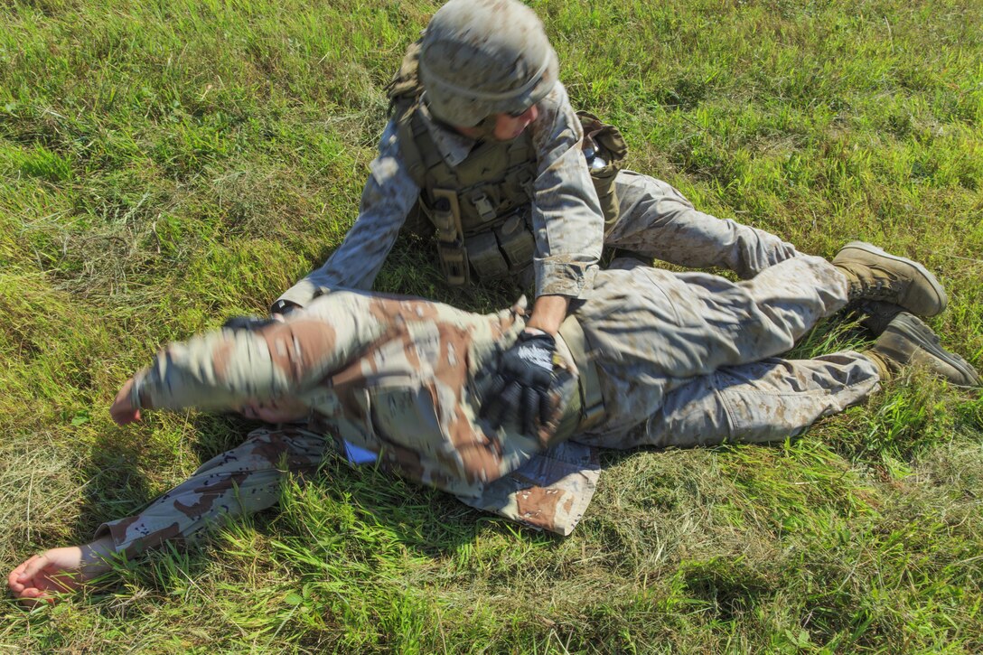 U.S. Marine Corps Pfc. Robert McCusker, Battalion Landing Team 1st Battalion, 6th Marine Regiment, 22nd Marine Expeditionary Unit (MEU), field radio operator and native of Lacey Township, N.J., searches a simulated casualty during a casualty evacuation drill as part of the MEU’s Realistic Urban Training exercise at Fort Pickett, Va., Aug. 30, 2013. During the drill, the Marines and Sailors learned how to insert by air, secure an area, triage the wounded and transport them to the nearest medical facility. The MEU is scheduled to deploy in early 2014 to the U.S. 5th and 6th Fleet areas of responsibility with the Bataan Amphibious Ready Group as a sea-based, expeditionary crisis response force capable of conducting amphibious missions across the full range of military operations. (U.S. Marine Corps photo by Cpl. Manuel A. Estrada/Released)
