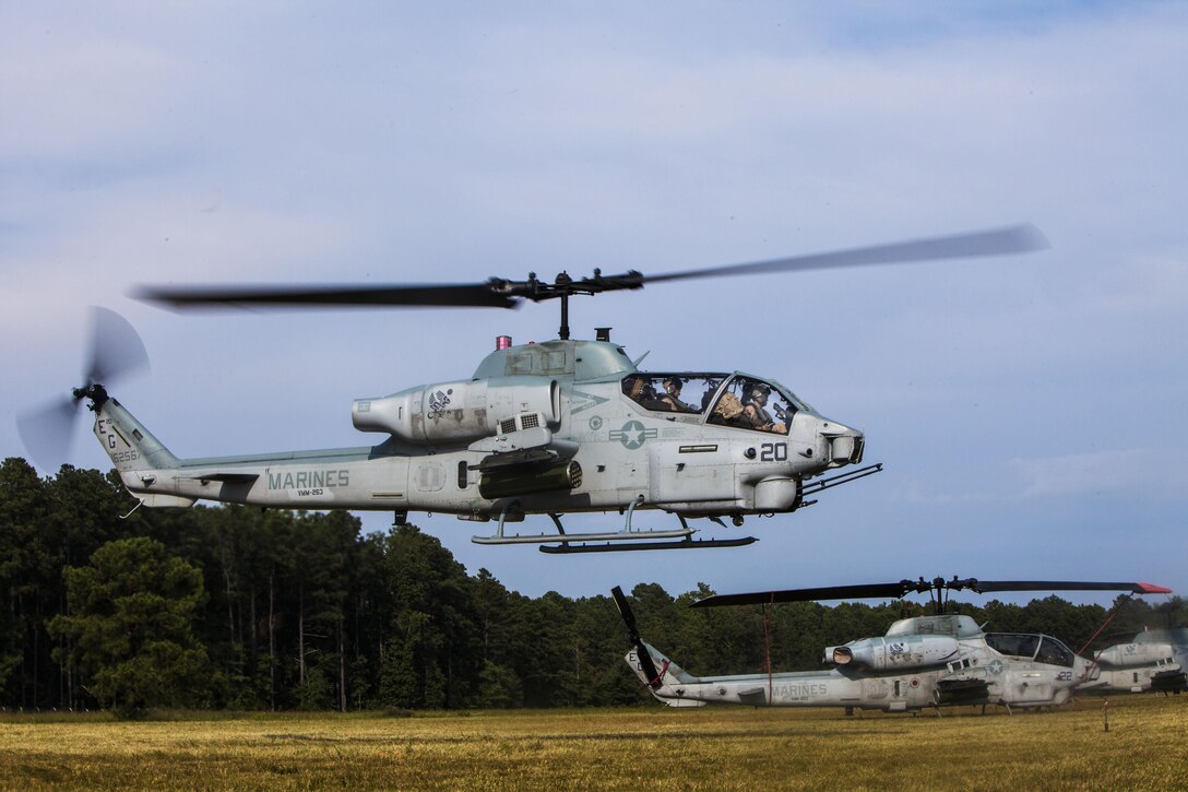 U.S. Marine Corps Capt. Chad Rudisill, left, Marine Medium Tiltrotor Squadron (VMM) 263 (Reinforced), 22nd Marine Expeditionary Unit (MEU), AH-1W Super Cobra pilot and native of Killeen, Texas, and Capt. Brett Collins, Super Cobra pilot and native of Portland, Ore., take off in support of the MEU’s Realistic Urban Training exercise at Fort Pickett, Va., Sept. 3, 2013. The MEU is scheduled to deploy in early 2014 to the U.S. 5th and 6th Fleet areas of responsibility with the Bataan Amphibious Ready Group as a sea-based, expeditionary crisis response force capable of conducting amphibious missions across the full range of military operations. (U.S. Marine Corps photo by Sgt. Austin Hazard/Released)