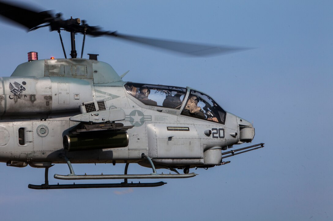 U.S. Marine Corps Capt. Chad Rudisill, left, Marine Medium Tiltrotor Squadron (VMM) 263 (Reinforced), 22nd Marine Expeditionary Unit (MEU), AH-1W Super Cobra pilot and native of Killeen, Texas, and Capt. Brett Collins, Super Cobra pilot and native of Portland, Ore., take off in support of the MEU’s Realistic Urban Training exercise at Fort Pickett, Va., Sept. 3, 2013. The MEU is scheduled to deploy in early 2014 to the U.S. 5th and 6th Fleet areas of responsibility with the Bataan Amphibious Ready Group as a sea-based, expeditionary crisis response force capable of conducting amphibious missions across the full range of military operations. (U.S. Marine Corps photo by Sgt. Austin Hazard/Released)