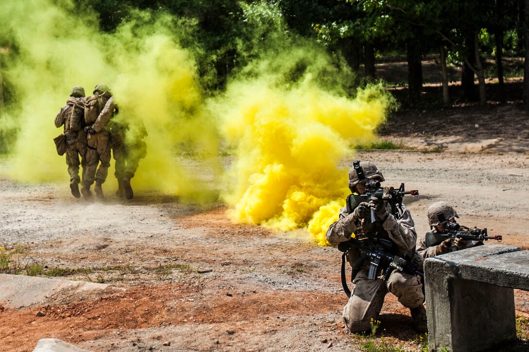 Two U.S. Marines with Battalion Landing Team (BLT) 1st Battalion, 6th Marine Regiment, 22nd Marine Expeditionary Unit (MEU), provide cover fire as Marines carry a simulated casualty to medical aid while conducting a platoon-sized raid on a simulated town during urban tactics training as part of the MEU’s Realistic Urban Training exercise at Fort Pickett, Va., Aug. 31, 2013. More than 160 Marines from the BLT practiced fire team and squad-level room and building clearings before progressing to platoon-sized raids on the town. The MEU is scheduled to deploy in early 2014 to the U.S. 5th and 6th Fleet areas of responsibility with the Bataan Amphibious Ready Group as a sea-based, expeditionary crisis response force capable of conducting amphibious missions across the full range of military operations. (U.S. Marine Corps photo by Sgt. Austin Hazard/Released)