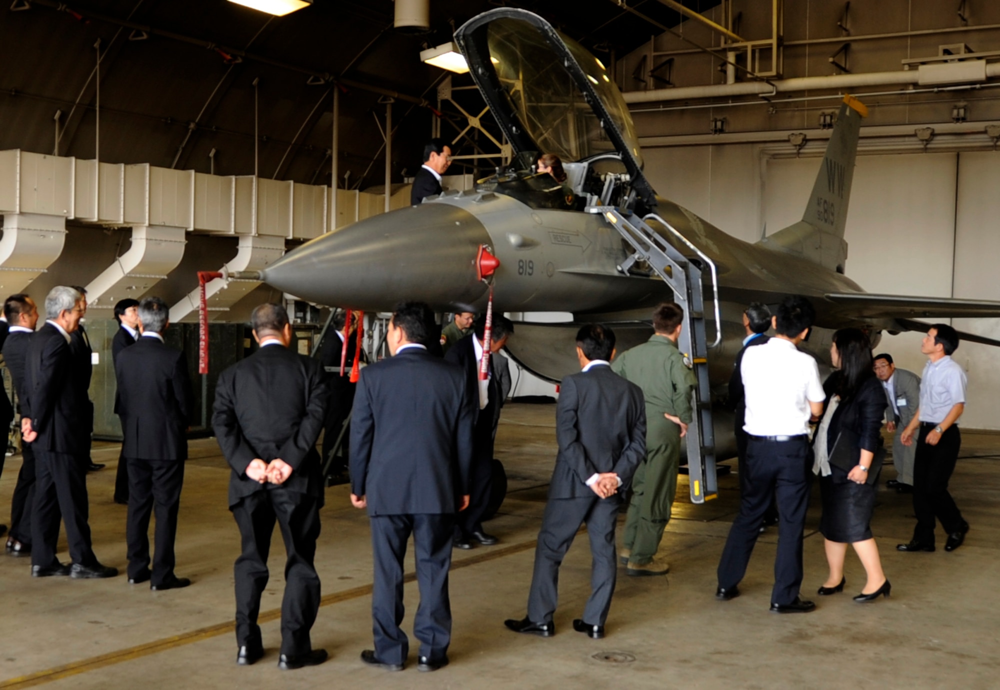 Members of the Military Base Host Communities Council view an F-16 Fighting Falcon static display at Misawa Air Base, Japan Sep. 6, 2013. The council members are from six municipalities where military facilities are located such as Misawa city. (U.S. Air Force photo by Airman 1st Class Kaleb Snay)