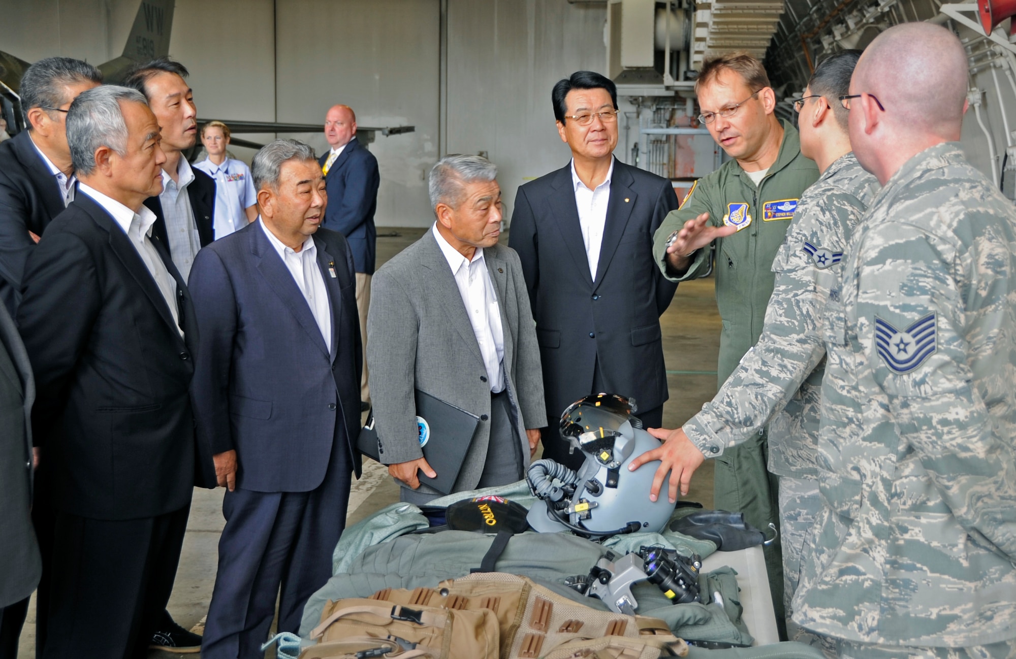 U.S. Air Force Col. Stephen Williams, 35th Fighter Wing commander, speaks about the equipment pilots use when flying an F-16 Fighting Falcon to the Military Base Host Communities Council at Misawa Air Base, Japan, Sep. 6, 2013. Members of the council toured Misawa Air Base to view an F-16 Fighting Falcon static display and learn about the strong bonds between Misawa Air Base and the local community. (U.S. Air Force photo by Airman 1st Class Kaleb Snay)