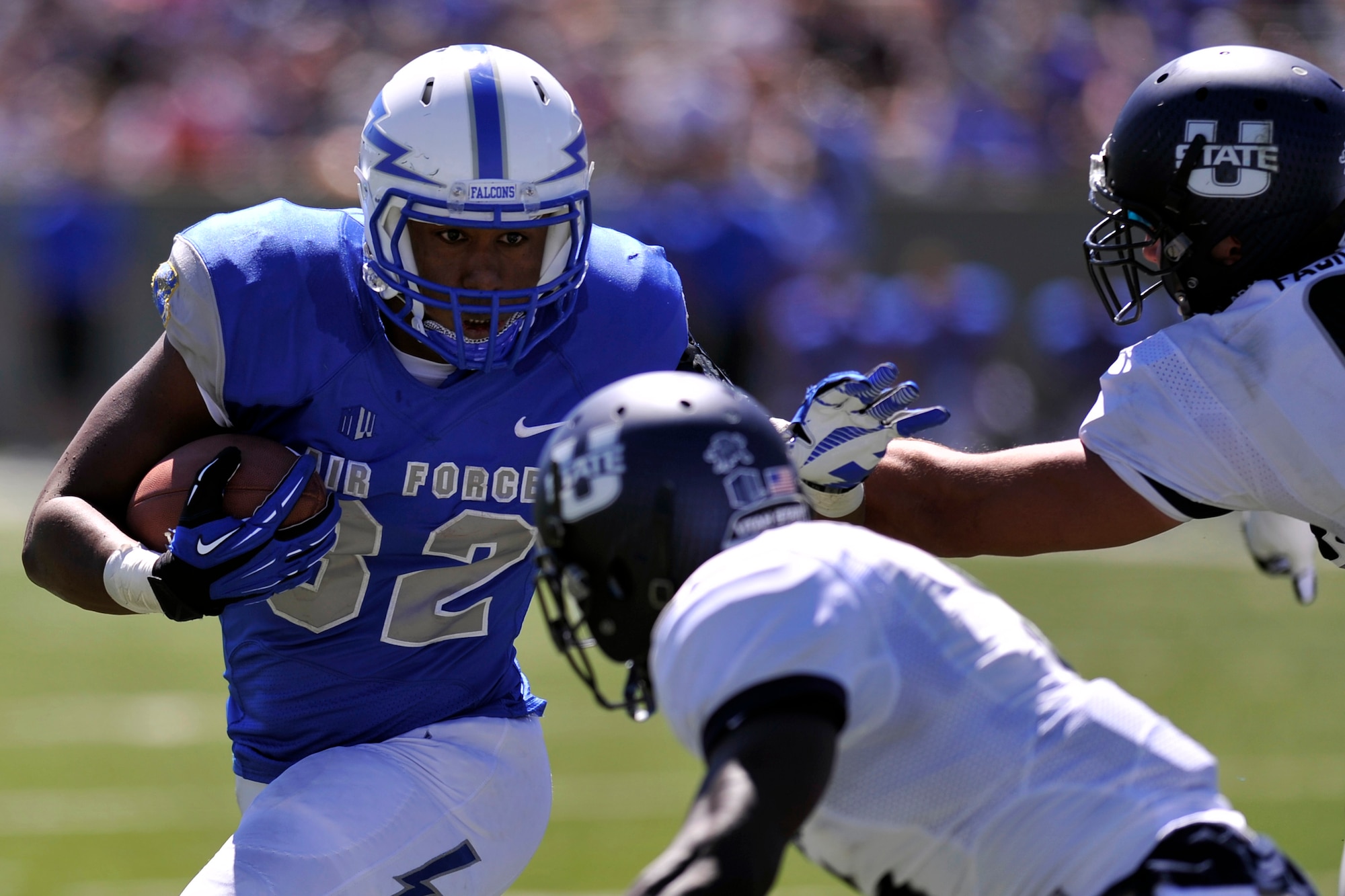 Air Force junior running back Broam Hart, looks for a hole in the Utah State defense during the Falcons' game against the Aggies at Falcon Stadium Sept. 7, 2013. Hart had seven rushes for 24 yards in Air Force's 52-20 loss. (U.S. Air Force photo/Raymond McCoy)