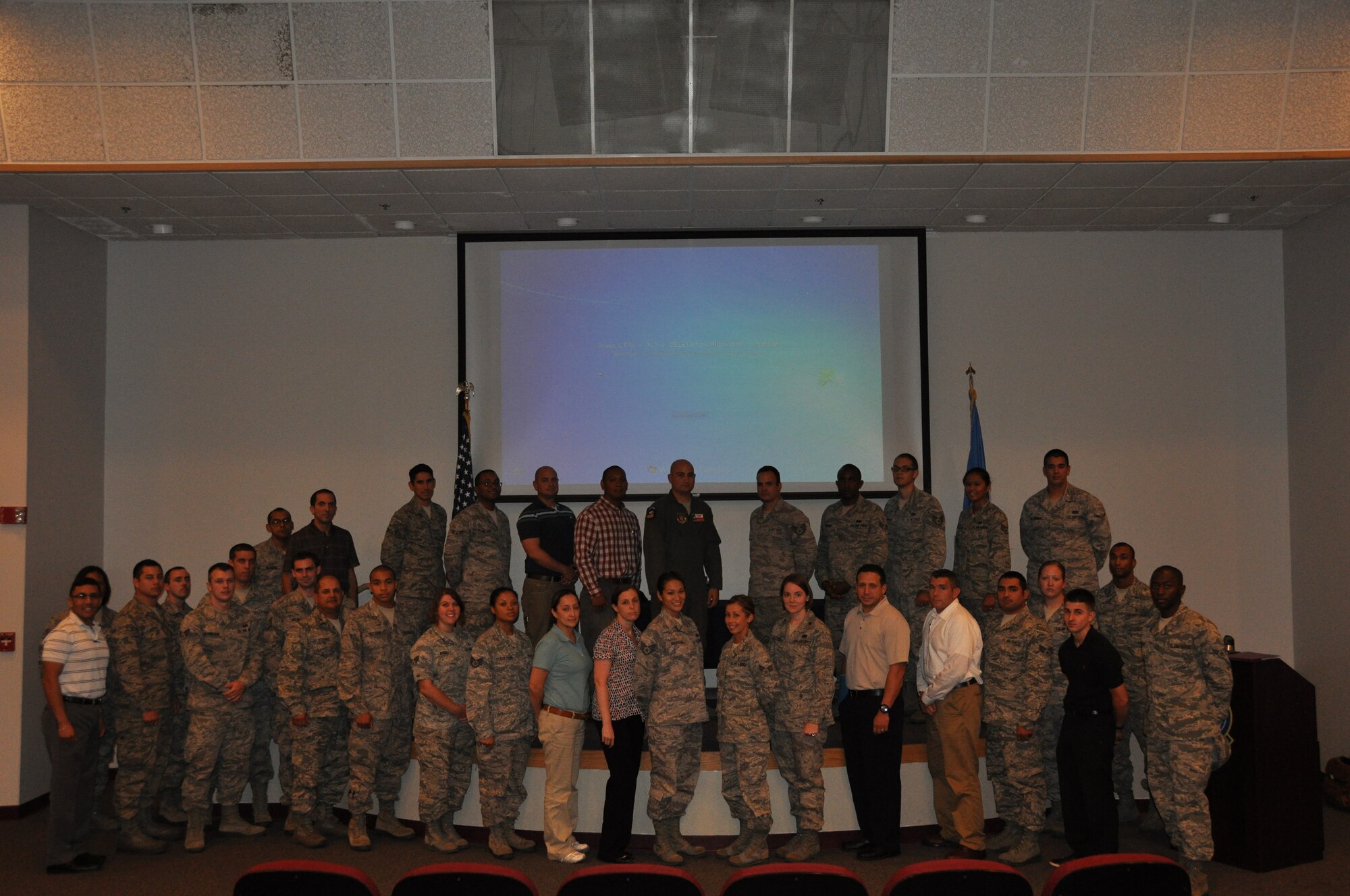 Over 30 new 433rd Airlift Wing Airmen gathered for a photo after the Newcomer’s Briefing on Sept. 8, 2013 before a bus tour of Joint Base San Antonio-Lackland, Texas.  The newcomer’s tour introduces them to the base and takes place after a series of briefings to familiarize them with the Alamo Wing. (Air Force photo by Tech Sgt. Carlos J. Trevino)