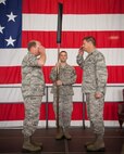 Col. Cam LeBlanc, 934th Maintenance Group commander, presides over the 934th Maintenance Operations Flight inactivation ceremony as the MOF flag is furled and Lt. Col. Marvin Schaitel, 934 MOF acting commander, relinquishes command.  (U.S. Air Force photo/Shannon McKay)