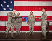 Col. Cam LeBlanc, 934th Maintenance Group commander, presides over the 934th Maintenance Operations Flight inactivation ceremony as the MOF flag is furled and Lt. Col. Marvin Schaitel, 934 MOF acting commander, relinquishes command.  (U.S. Air Force photo/Shannon McKay)