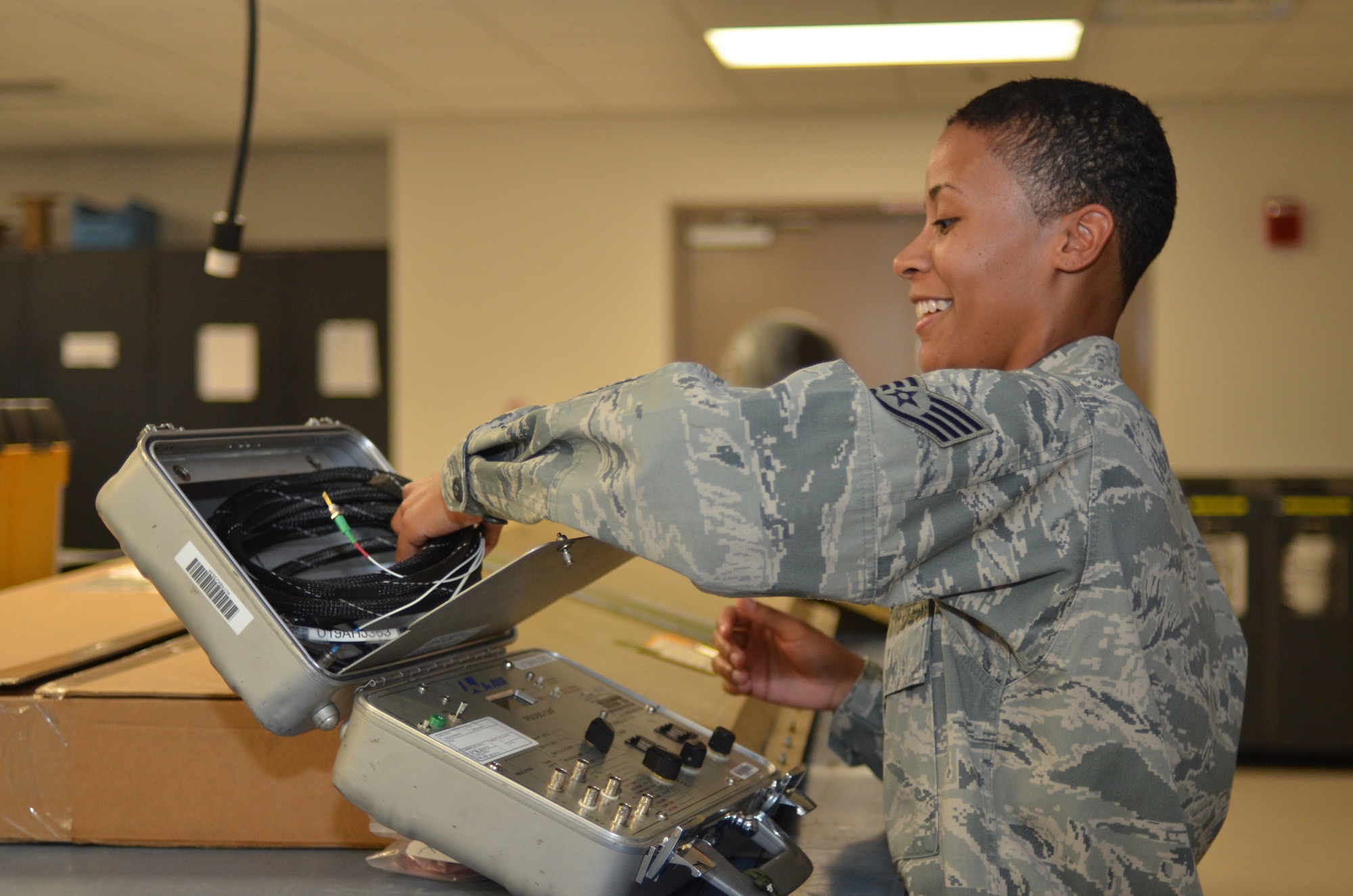 A newly promoted Staff Sgt. Jennafur Williams, integrated avionics guidance and control specialist, 920th maintenance squadron, puts away some gear during her last unit training assembly with 920th Rescue Wing, Patrick Air Force Base, Fla., Sept. 8, 2013. Williams became the wings first reservists to be awarded the John L. Levitow award after completing Airman Leadership School Aug. 29, 2013. (U.S. Air Force photo/Senior Airman Natasha Dowridge)