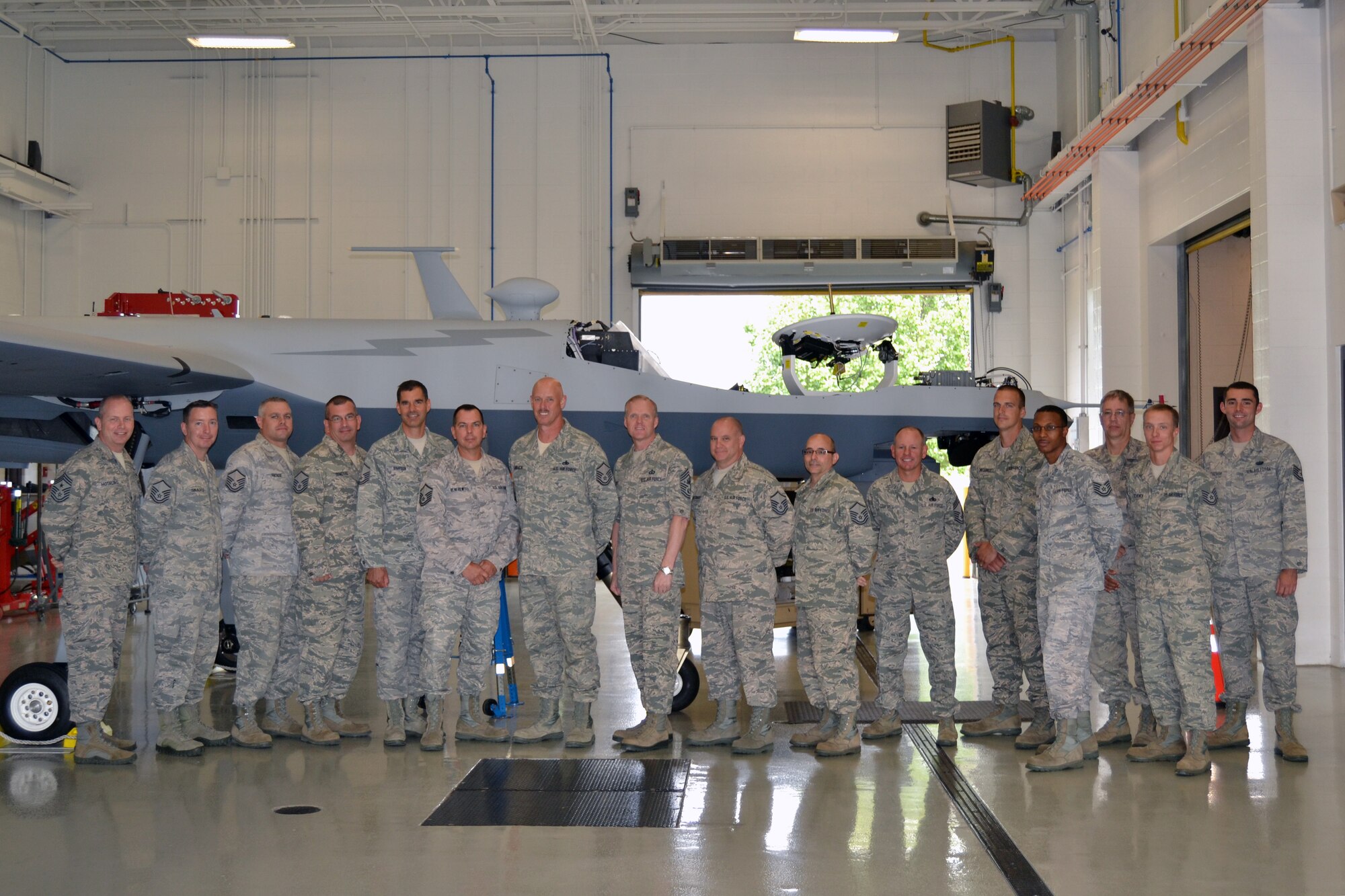 Chief Master Sgt. of the Air Force James A. Cody (eigth from left), along with Command Chief Master Sgt. James Hotaling of the Air National Guard, toured the 174th Attack Wing, Hancock Field on Sep. 7, 2013. Cody visited Hancock Field to meet with Airmen, get the pulse of the enlisted force and answer questions. Cody, Hotaling and MQ-9 maintenance trainers take time to pose in front of the Reaper. (Photo by New York Air National Guard Maj. Sandra Stoquert)