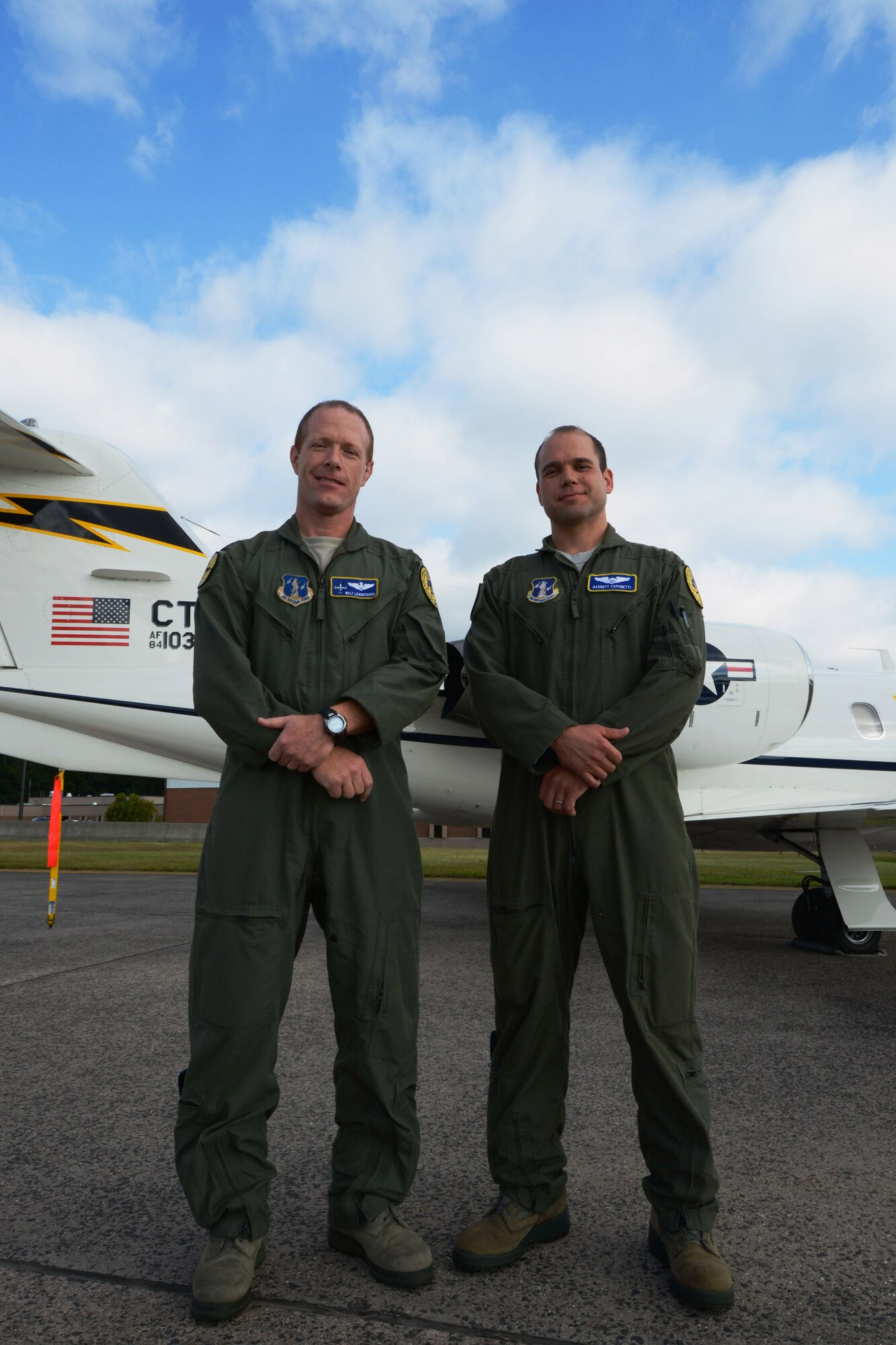 Lt. Col. Walt Levantovich and Capt. Garrett Caponetti, both pilots with the 103rd Airlift Wing, Connecticut Air National Guard, pose in front of one of the wing's C-21s at Bradley Air National Guard Base, East Granby, Conn., Sept. 8, 2013. Levantovich and Caponetti stopped at the scene of a multi-vehicle crash and rendered first aid to two children after rescuing them from an overturned vehicle September 6. The severity of the accident caused a shutdown of all southbound traffic on I-91 in Windsor, Conn. (U.S. Air National Guard photo by Senior Airman Jennifer Pierce)