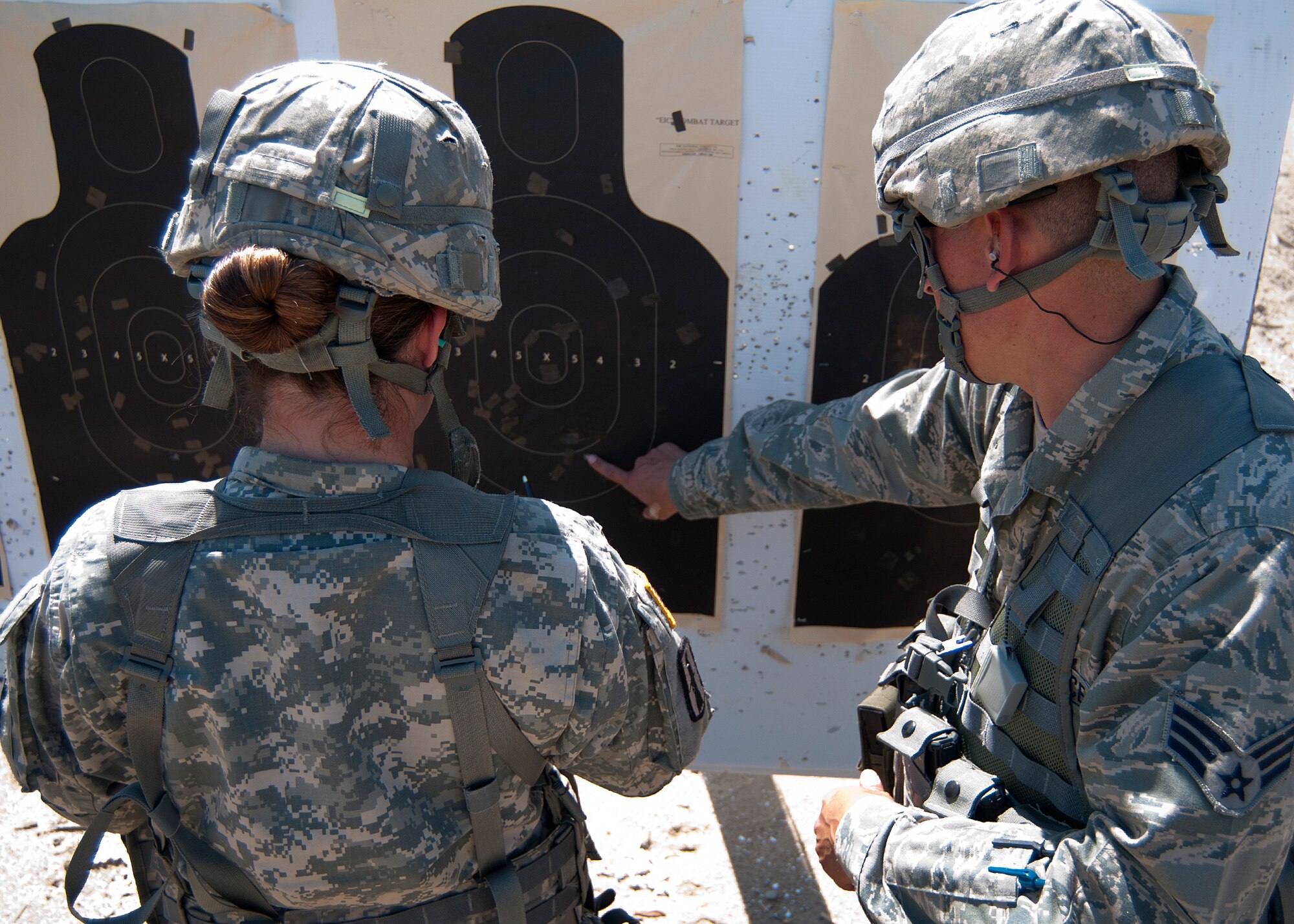 FORT DEVENS, Mass. – New Hampshire Air National Guard Senior Airman Nelson Elias, right, and N.H. Army National Guard Sgt. Jacinta Crooker, count rounds that hit the target during the state marksmanship competition here Aug. 25. Members of the N.H. National Guard squared off in a marksmanship competition Aug. 23 through 25 to determine who the best at pistol, rifle and team competitors were for 2013. (N.H. National Guard photo by Tech. Sgt. Mark Wyatt/Released)