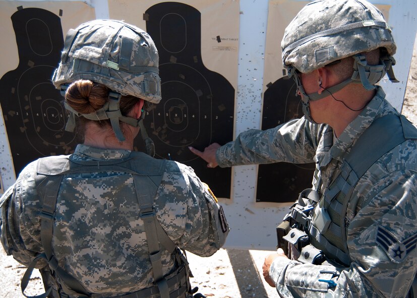 FORT DEVENS, Mass. – New Hampshire Air National Guard Senior Airman Nelson Elias, right, and N.H. Army National Guard Sgt. Jacinta Crooker, count rounds that hit the target during the state marksmanship competition here Aug. 25. Members of the N.H. National Guard squared off in a marksmanship competition Aug. 23 through 25 to determine who the best at pistol, rifle and team competitors were for 2013. (N.H. National Guard photo by Tech. Sgt. Mark Wyatt/Released)