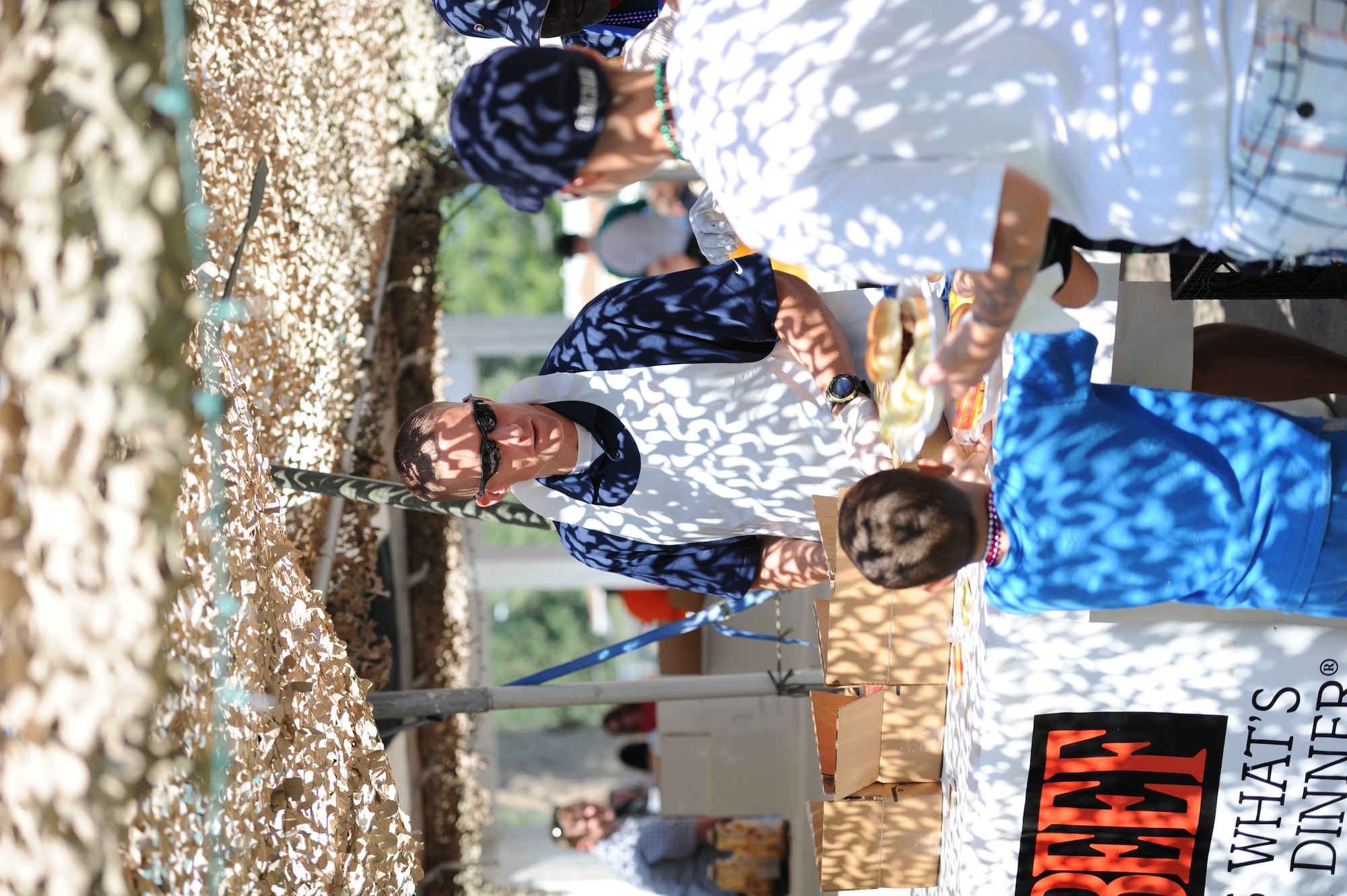 Maj. Ryan Bodge, 366th Security Forces Squadron commander, serves a free meal of pulled pork, chips and beverages to patrons at the 2013 Air Force Appreciation Day parade and celebration in Mountain Home, Idaho, Sept. 7, 2013. The parade is the longest in Idaho, and this year marked the 53rd AFAD celebration. (U.S. Air Force photo by Master Sgt. Kevin Wallace/RELEASED)