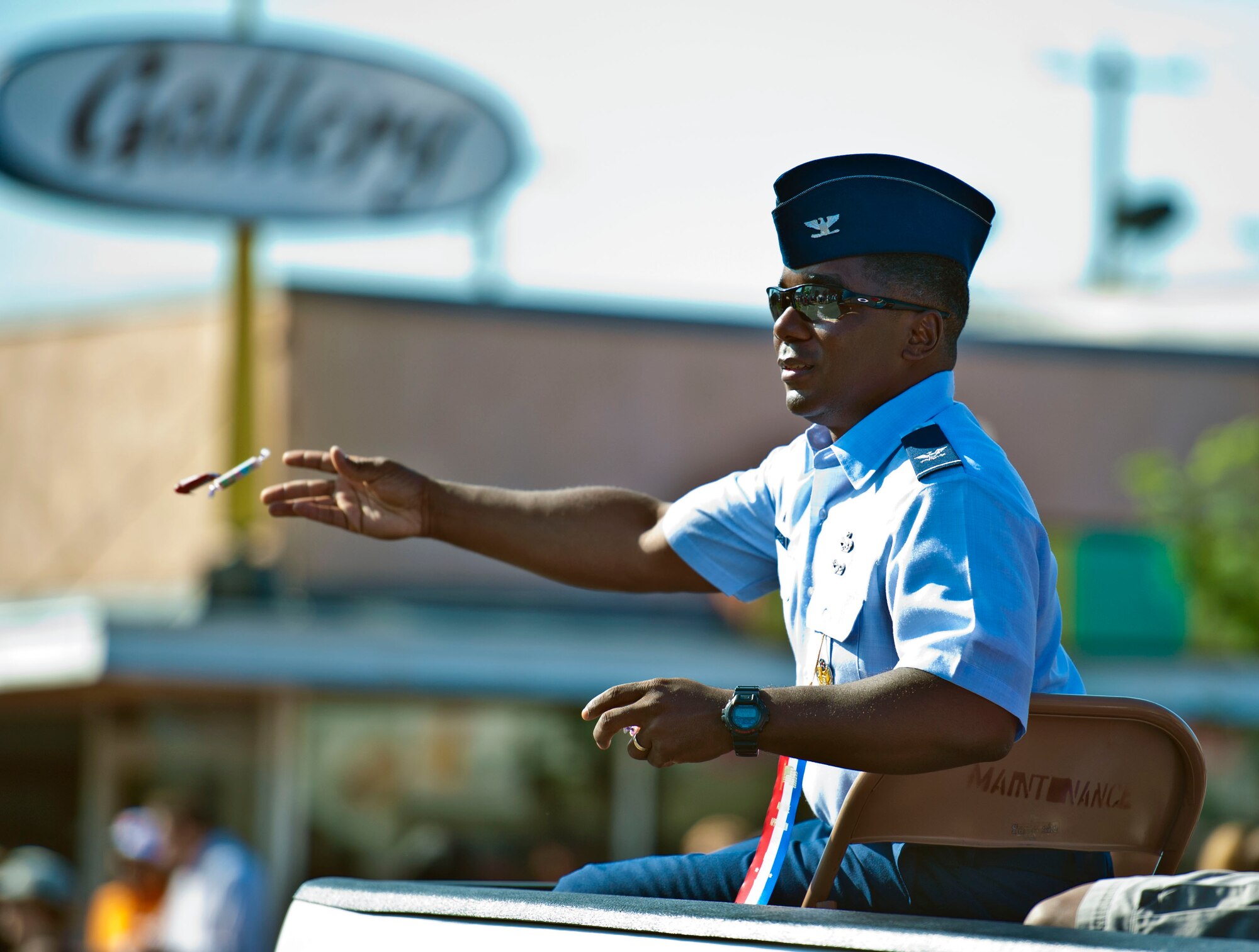 Col. Michael Lawrence, 366th Maintenance Group commander, throws candy to kids during the 2013 Air Force Appreciation Day parade in Mountain Home, Idaho, Sept. 7, 2013. The 366th Fighter Wing commander, Col. Christopher Short, the command chief, and all group commanders rode in the parade, which is the longest in Idaho, and this year marked the 53rd AFAD celebration. (U.S. Air Force photo by Master Sgt. Kevin Wallace/RELEASED)