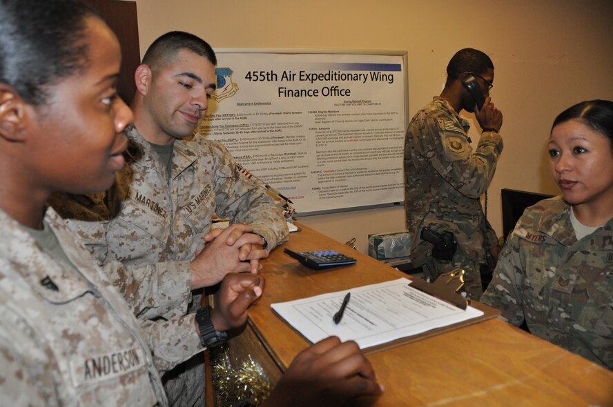 Tech. Sgt. Karina Myers, 455th Air Expeditionary Wing financial management NCOIC, deployed from Dyess Air Force Base, Texas, and a native of Houston, assists U.S. Marines SGT John Martinez and CPL Showni Anderson at Bagram Airfield, Afghanistan, Sept. 3. The 455th Air Expeditionary Wing finance management office not only provides financial customer service, it also plays an important role in the accomplishment of the 455 AEW mission by executing the wing budget to fund all mission requirements. (U.S. Air Force photo/Tech. Sgt. Rob Hazelett)