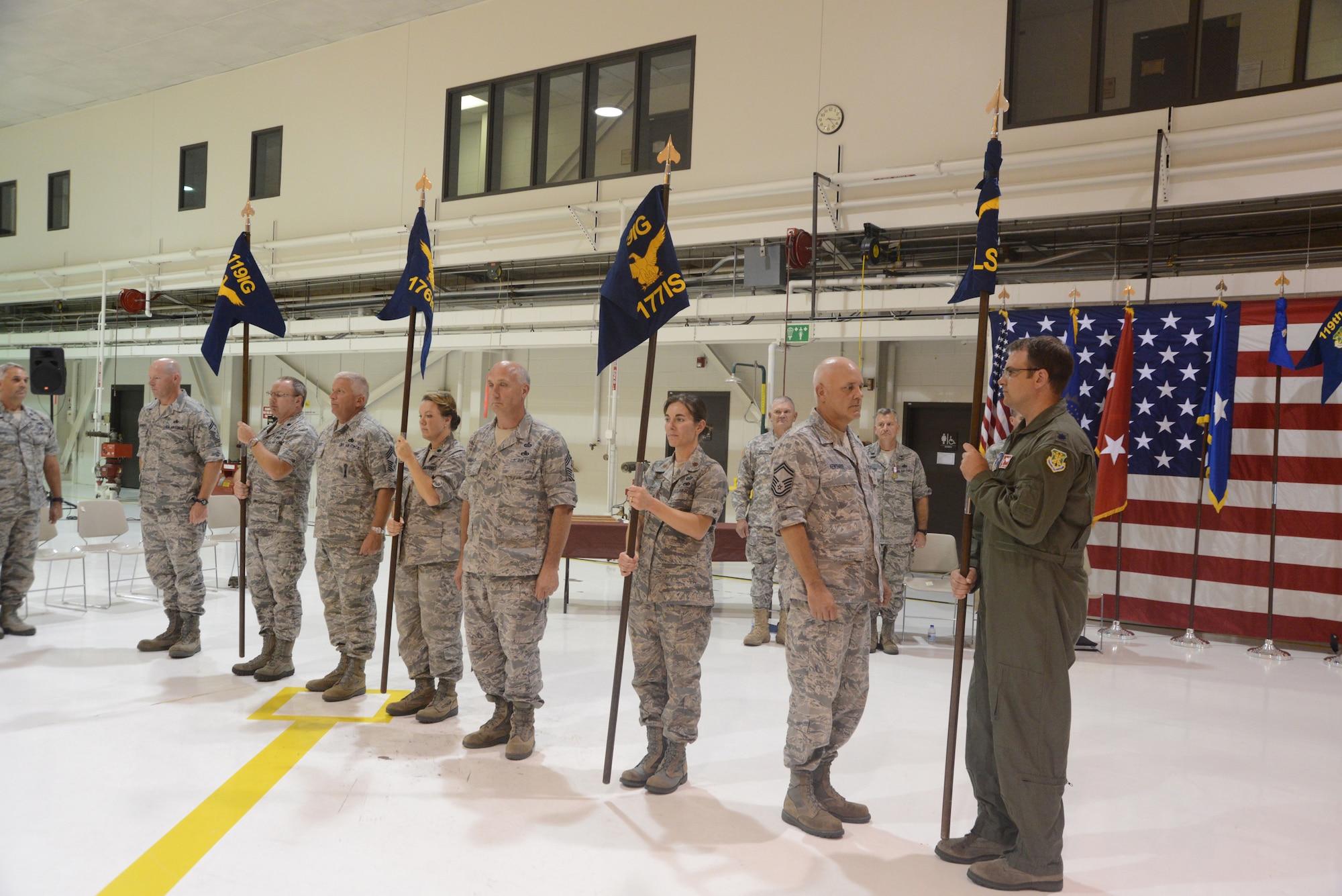 New 119th Intelligence Squadron commanders and enlisted leaders present new squadron guidons during a redesignation and activation ceremony Sep. 7, 2013, at the North Dakota Air National Guard Base, Fargo, N.D. During the ceremony, the 119th Maintenance Group was redesignated the 119th Intelligence Group, signaling the change to the Airmen’s missions. (U.S. Air National Guard photo by SMSgt. David H. Lipp/Released)