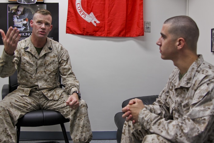 Sergeant Major Peter W. Ferral, Headquarters and Headquarters Squadron sergeant major, gives Pfc. David S. Dignetti, H&HS aviation operation specialist, a positive counseling for his Hard Charger of the Week achievement Aug. 19, 2013. Growing up in a Marine Corps household, joining the Marine Corps out of high school, and due to positive leaders and role models throughout his days as a junior Marine, Ferral has been equipped with the tools to give him the ability to lead from the front and motivate younger Marines. When Ferral sees younger Marines leading from the front and motivating all Marines, regardless of rank, he said that is what keeps him motivated.