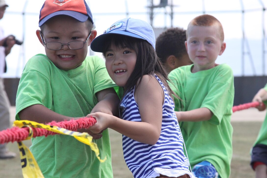 Scouts from Troop 77 play tug-of-war with Japanese scouts from Iwakuni at Penny Lake field aboard Marine Corps Air Station Iwakuni, Japan, during the Iwakuni Day Camp “Space is the Place” event, August 18, 2013. Tug-of-war was one of many games played during Iwakuni Day Camp field day.  
