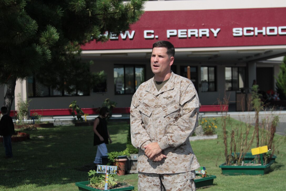 Col. Bob Boucher, Marine Corps Air Station Iwakuni, Japan, commanding officer, delivers his opening remarks in front of the Matthew C. Perry Elementary School here, Aug. 26, 2013. Boucher encouraged the kids to set goals for the new school year, encouraged the parents to volunteer and raise awareness to the issues of absences and tardiness.