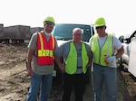 James Stroh, left, a former Wisconsin Guard member, stands with Wayne Brooks, the police chief in Zion, Ill., and Staff Sgt. Andrew Whelan, a Wisconsin Army National Guard recruiter from Waukesha, Wis., Aug. 24 during a search for the remains of a murdered infant at a landfill in Zion.