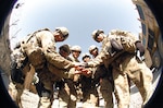 Staff Sgt. Charles Chiguina, left, convoy commander for Charlie Company, 1-294th Infantry Regiment, Guam Army National Guard, and members of his team show their unity prior to a June 22 mission at Camp Eggers, Kabul, Afghanistan.