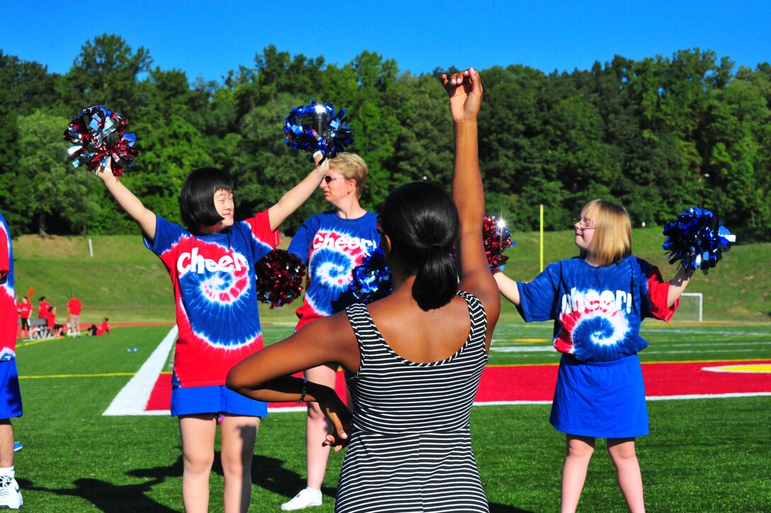 Cheerleaders bring motivation to the Special Olympics track and field meet aboard Marine Corps Base Quantico on Sept. 7, 2013. More than 65 athletes, ages five and up, participated in the event.