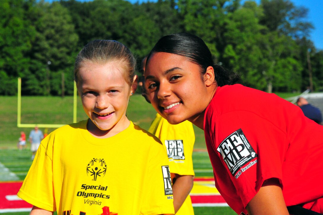 Breanna, 10, and Lance Cpl. Amanda Rivera posed for a picture during the Special Olympics track and field meet aboard Marine Corps Base Quantico on Sept. 7, 2013. Over 65 athletes attended the event and each had their own escort to assist them throughout the course.