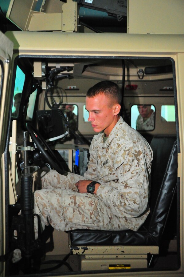 Lance Cpl. Dylan Stephens, team leader, uses a simulator at the Reserve Support Unit aboard Marine Corps Base Quantico on Sept. 6, 2013. More than 50 Marines from 1st Fleet Antiterrorism Security Team out of Norfolk, Va., conducted training with the Virtual Combat Convoy Trainer. 