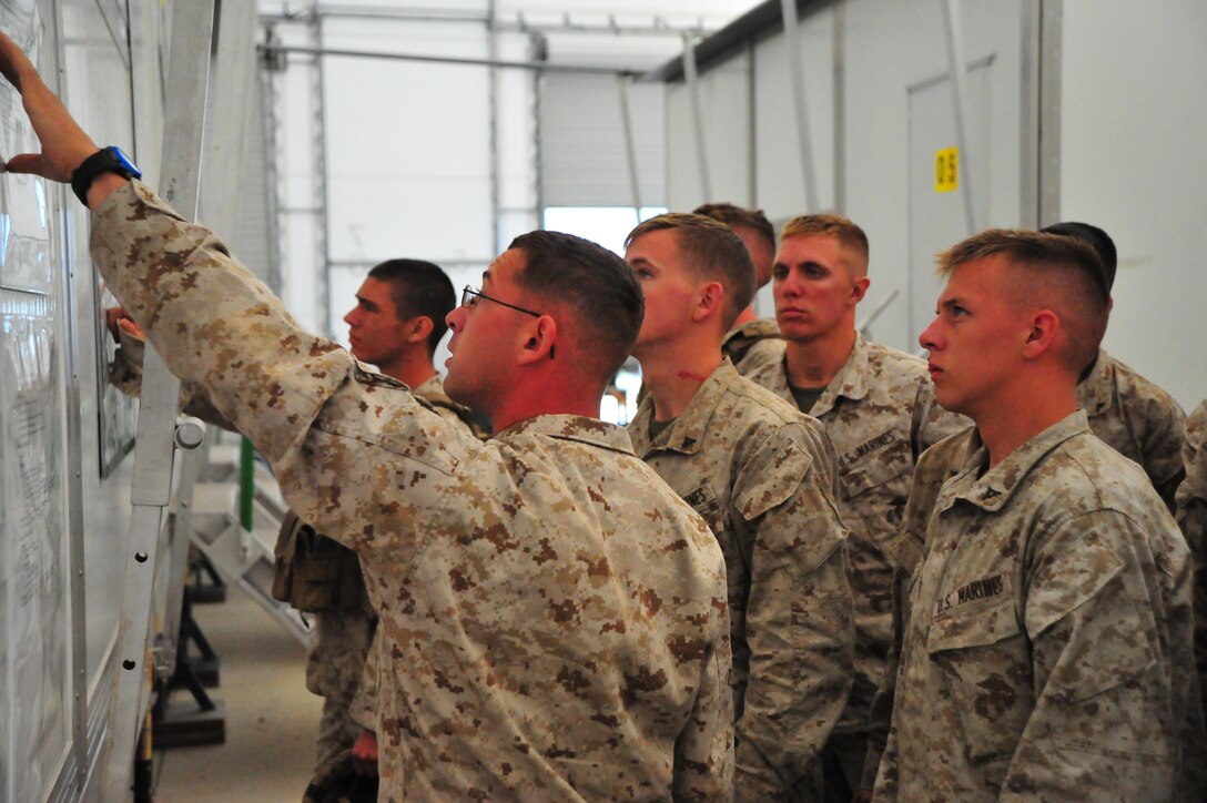 Sgt. Cordy Gaeta, 1st Fleet Antiterrorism Security Teams squad leader, briefs Marines to use a simulator at the Reserve Support Unit aboard Marine Corps Base Quantico on Sept. 6, 2013. Over 50 Marines from the 1st FAST out of Norfolk, Va., conducted training with the Virtual Combat Convoy Trainer. 