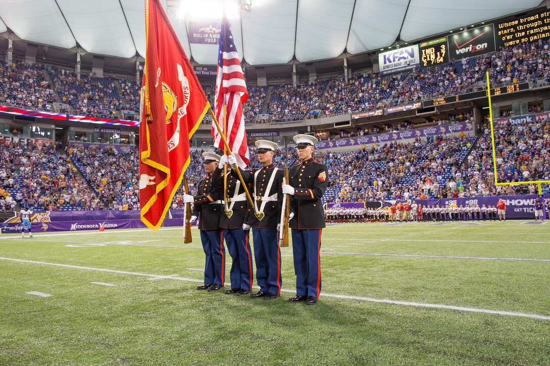 Marines with Recruiting Station Twin Cities present the colors at Mall of America Field during the Minnesota Vikings' pre-season football game against the Tennessee Titans Aug. 29. The four recruiters work out of the Burnsville, Minn., and Lakeville, Minn., offices. 