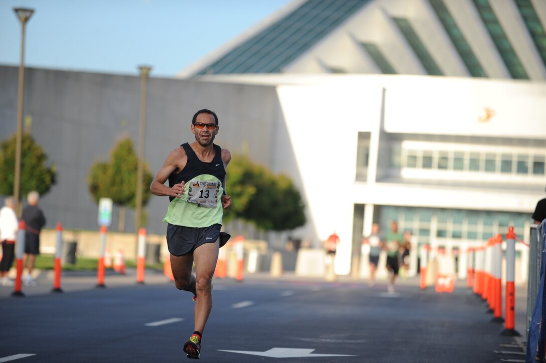 Joseph Apodaca, 52, Manassa, Va., finishes the Crossroads 4-Miler hosted by the Marine Corps Marathon. The finish line was in front of the National Museum of the Marine Corps.
