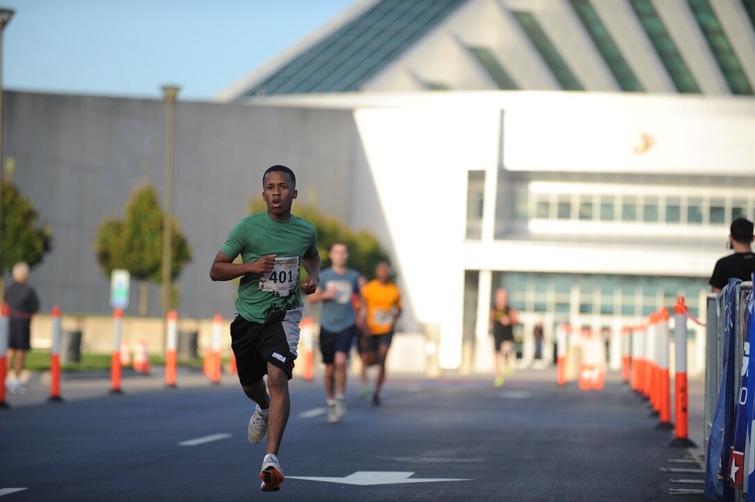 Demetri Sanders, 20, Quantico, finishes the Crossroads 4-Miler hosted by the Marine Corps Marathon. The finish line was in front of the National Museum of the Marine Corps.