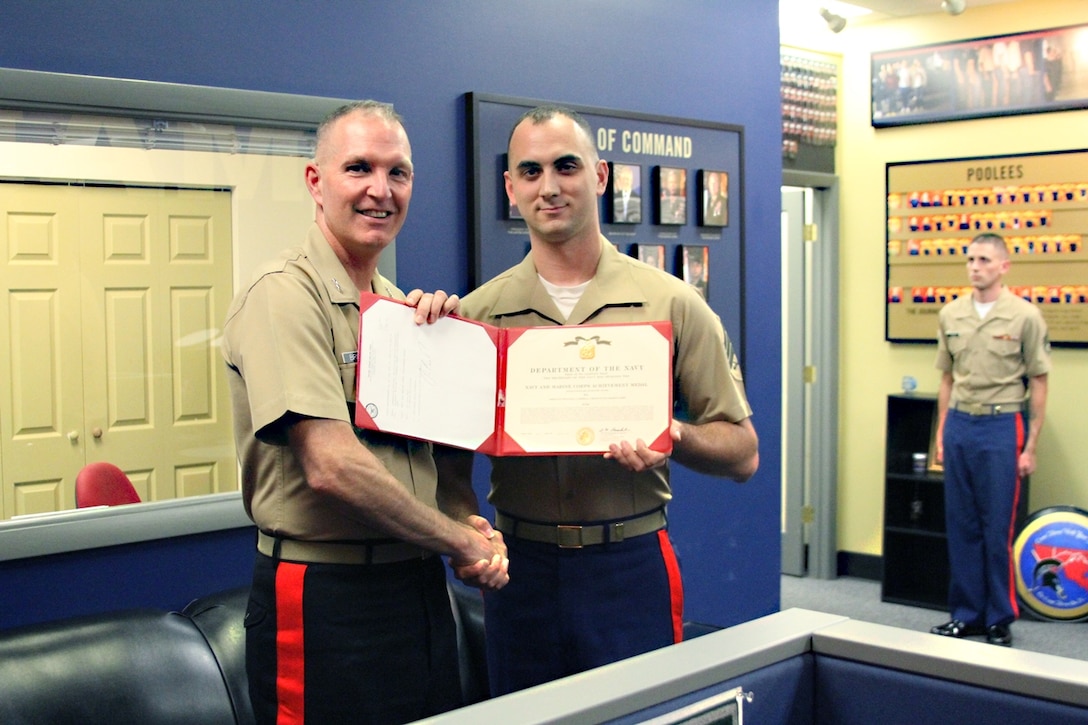 U.S. Marine Corps Maj. Gen. Mark A. Brilakis, Commanding General of Marine Corps Recruiting Command, presents U.S. Marine Corps Sgt. William Campbell a Frederick, Md. native, with the Navy and Marine Corps Achievement Medal Sept. 4, 2013 in Frederick, Md. The medal was awarded for Campbell’s success and accomplishments while on recruiting duty.  (U.S. Marine Corps photo by Sgt. Joshua Richards/Released)