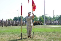 Gunnery Sgt. Mark Sink with Combat Logistics Regiment 4 posts the guidon for his former unit Sept. 8 in Kansas City, Mo. the ceremony marks the end of the 24th Marine Regiment prestigious history.