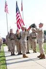 Col. Charles Sides, the commanding officer of 24th Marine Regiment, uncases the Combat Logistics Regiment 4 colors during a ceremony Sept. 8 in Kansas City, Mo. The ceremony marks the end of the 24th Marine Regiments prestigious history.