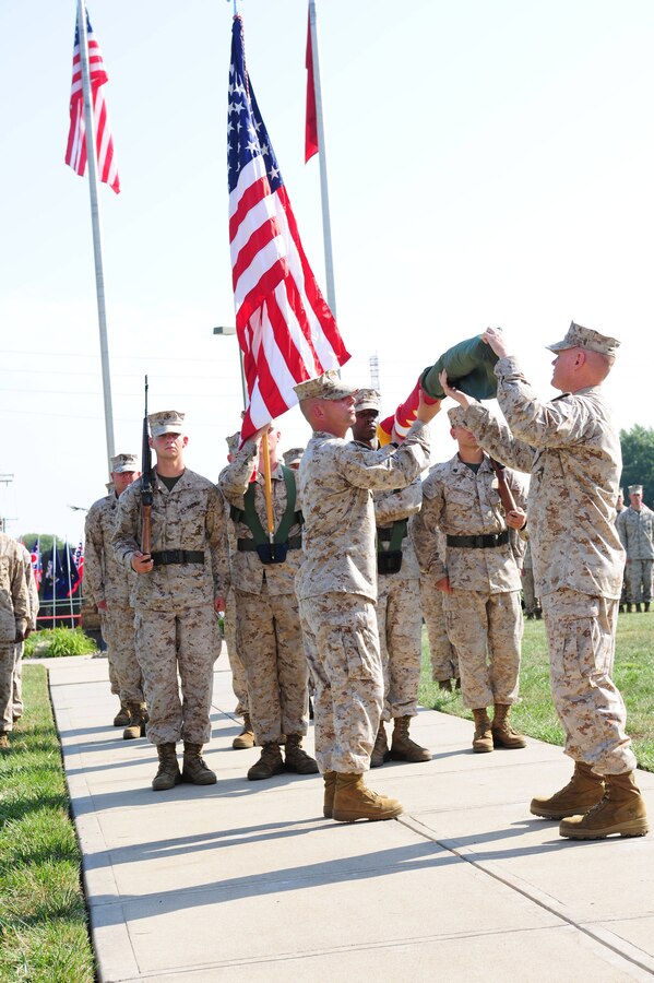 Col. Charles Sides, the commanding officer of 24th Marine Regiment, uncases the Combat Logistics Regiment 4 colors during a ceremony Sept. 8 in Kansas City, Mo. The ceremony marks the end of the 24th Marine Regiments prestigious history.