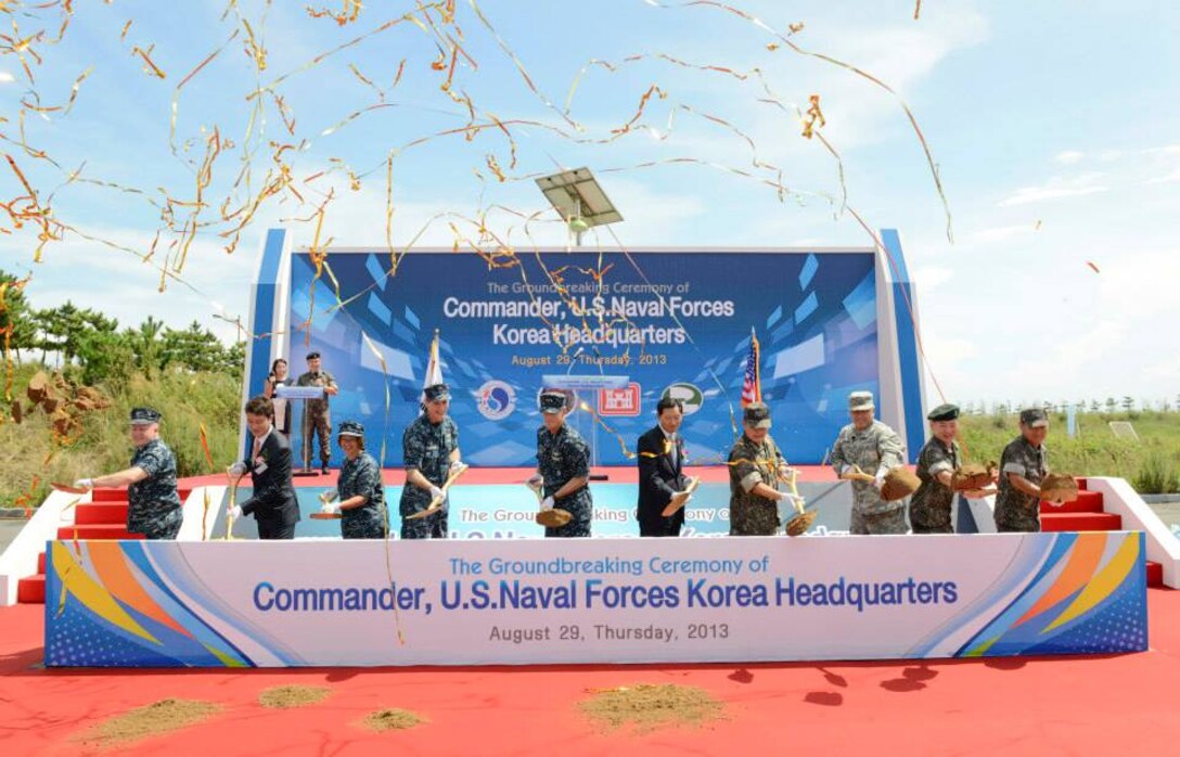 BUSAN, Republic of Korea  - Rear Adm. William McQuilkin, Commander of U.S. Naval Forces Korea, Vice Adm. Robert L. Thomas, Jr., commander, U.S. 7th Fleet, Vice Adm. Jung, Ho Sup, commander, Republic of Korea (ROK) Navy Fleet; Rear Adm. Lisa Franchetti and other distinguished guests break ground on the future Navy headquarters building on the ROK Navy base in Busan, Aug. 29. Commander, Naval Forces Korea headquarters is currently based in Seoul and is scheduled to relocate to Busan in 2015. (U.S. Navy photo by Mass Communication Specialist 1st Class Joshua Bryce Bruns)