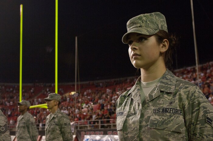 Airman 1st Class Caroline Rulison, 99th Aerospace Medicine Squadron aerospace medicine technician, stands ready to play her part in the presentation of the American flag before the University of Nevada Las Vegas Rebels’ season opening football game against the University of Arizona Wildcats Sept. 7, 2013, in Las Vegas.  Prior to the game, Airmen were recognized by the local community for their service. (U.S. Air Force photo by Airman 1st Class Joshua Kleinholz)