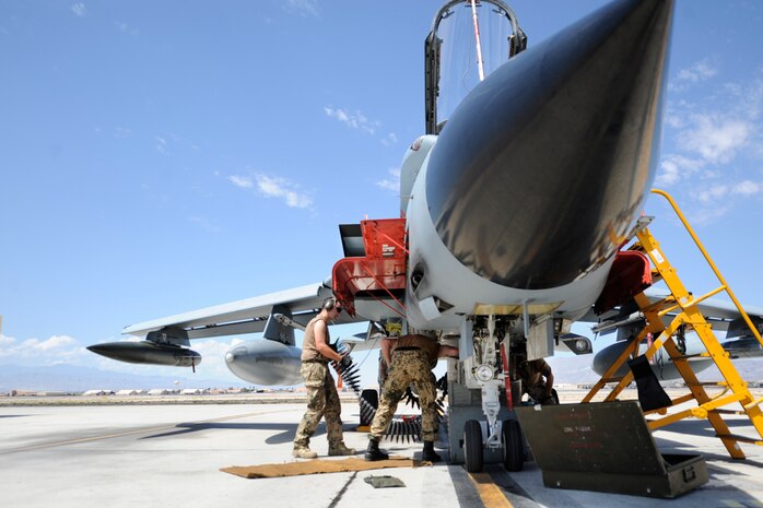 A German air force munitions specialist, assigned to the 33rd Fighter Bomber Wing, Buechel Air Base, Germany, loads a 27mm ammunition box onto a PA 200 Tornado prior to a training mission during a Green Flag-West exercise Sept. 5, 2013, at Nellis Air Force Base, Nev. The Mauser, BK-27 revolver cannon is internally mounted under each side of the fuselage and holds 180 rounds per side. (U.S. Air Force Photo by Lorenz Crespo)