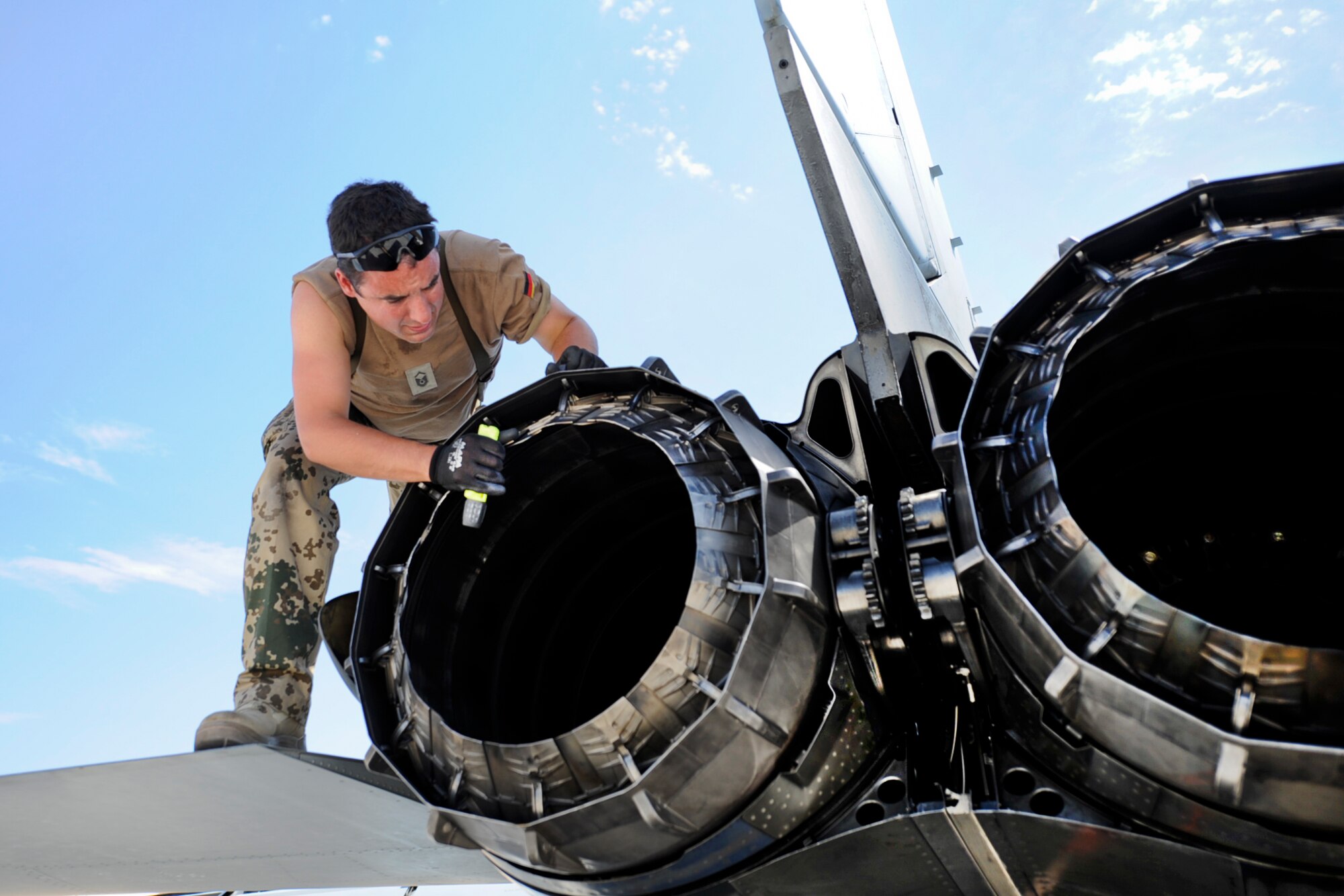 German air force Master Sgt. Michael Gutmann, 33rd Fighter Bomber Wing crew chief, Buechel Air Base, Germany, performs a post-flight inspection on a PA 200 Tornado’s RB 199 Rolls Royce engine after a training mission during a Green Flag-West exercise Sept. 5, 2013, at Nellis Air Force Base, Nev. The turbofan jet engine was designed and built in the early 1970s by Turbo-Union, a joint venture between Rolls-Royce and Fiat Avio. (U.S. Air Force Photo by Lorenz Crespo)