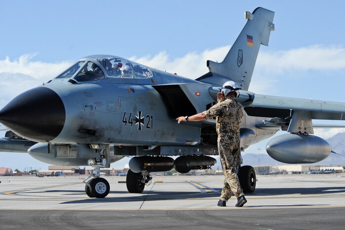 A German air force crew chief assigned to the 33rd Fighter Bomber Wing, Buechel Air Base, Germany, launches a PA 200 Tornado for a training mission during a Green Flag-West exercise Sept. 5, 2013, at Nellis Air Force Base, Nev. Green Flag exercises provide coalition and joint training for approximately 75,000 warfighters per year, including 3,000 sorties, 6,000 flight hours and the expenditure of more than 700,000 pounds of live and training ordnance. (U.S. Air Force Photo by Lorenz Crespo)