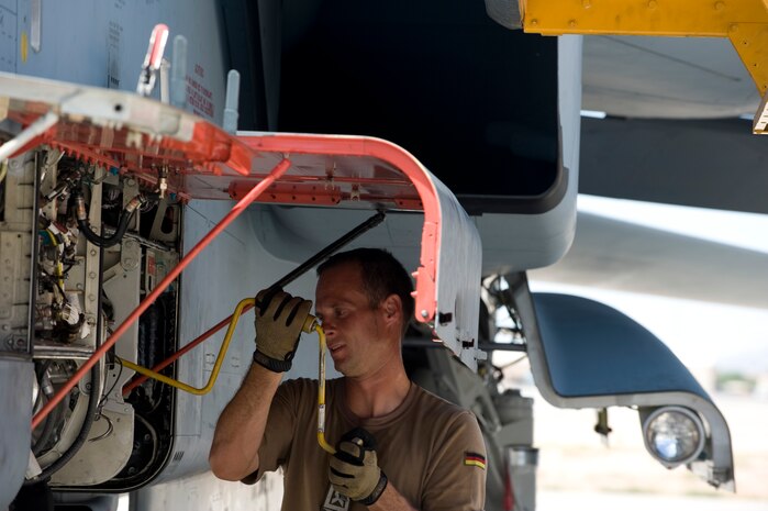 German air force Master Sgt. Steffen Werking-Eckes, 33rd Fighter Bomber Wing crew chief, Buechel Air Base, Germany, installs a weapons box on a PA 200 Tornado during a Green Flag-West exercise Sept. 5, 2013, at Nellis Air Force Base, Nev. The German air force’s participation in the U.S. Air Force's Green Flag exercise builds international air force cooperation, interoperability and mutual support. (U.S. Air Force Photo by Senior Airman Matthew Lancaster) 