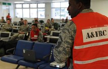 U.S. Air Force Master Sgt. Devin Wright, 18th Force Support Squadron Airman and family readiness center readiness NCO, gives a pre-deployment briefing at a personnel deployment function line during a local operational readiness exercise on Kadena Air Base, Japan, Sept. 9, 2013. PDF lines are used to ensure personnel have the necessary items needed to deploy, such as equipment, paperwork and intel. (U.S. Air Force photo by Airman 1st Class Keith A. James)