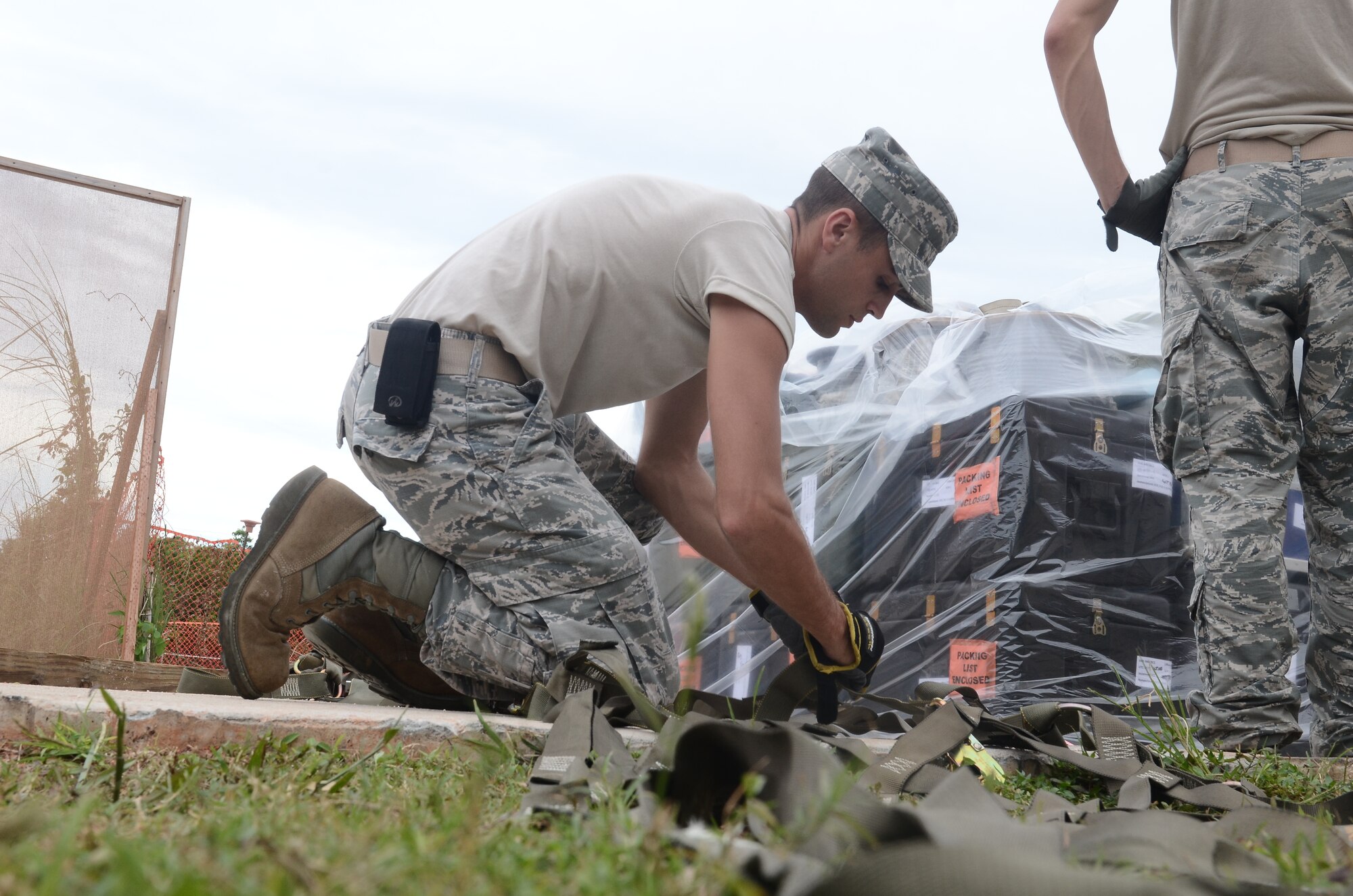 Staff Sgt. Kyle Koutsouros, 644th Combat Communications Squadron radio frequency transmissions system craftsman, straps down cargo for a deployment line during Exercise Beverly Palms 13-05 on Andersen Air Force Base, Guam, Sept. 9, 2013. During the exercise, Andersen Airmen practiced their ability to react, defend and execute operations in a wartime scenario. (U.S. Air Force photo by Airman 1st Class Adarius Petty/Released)