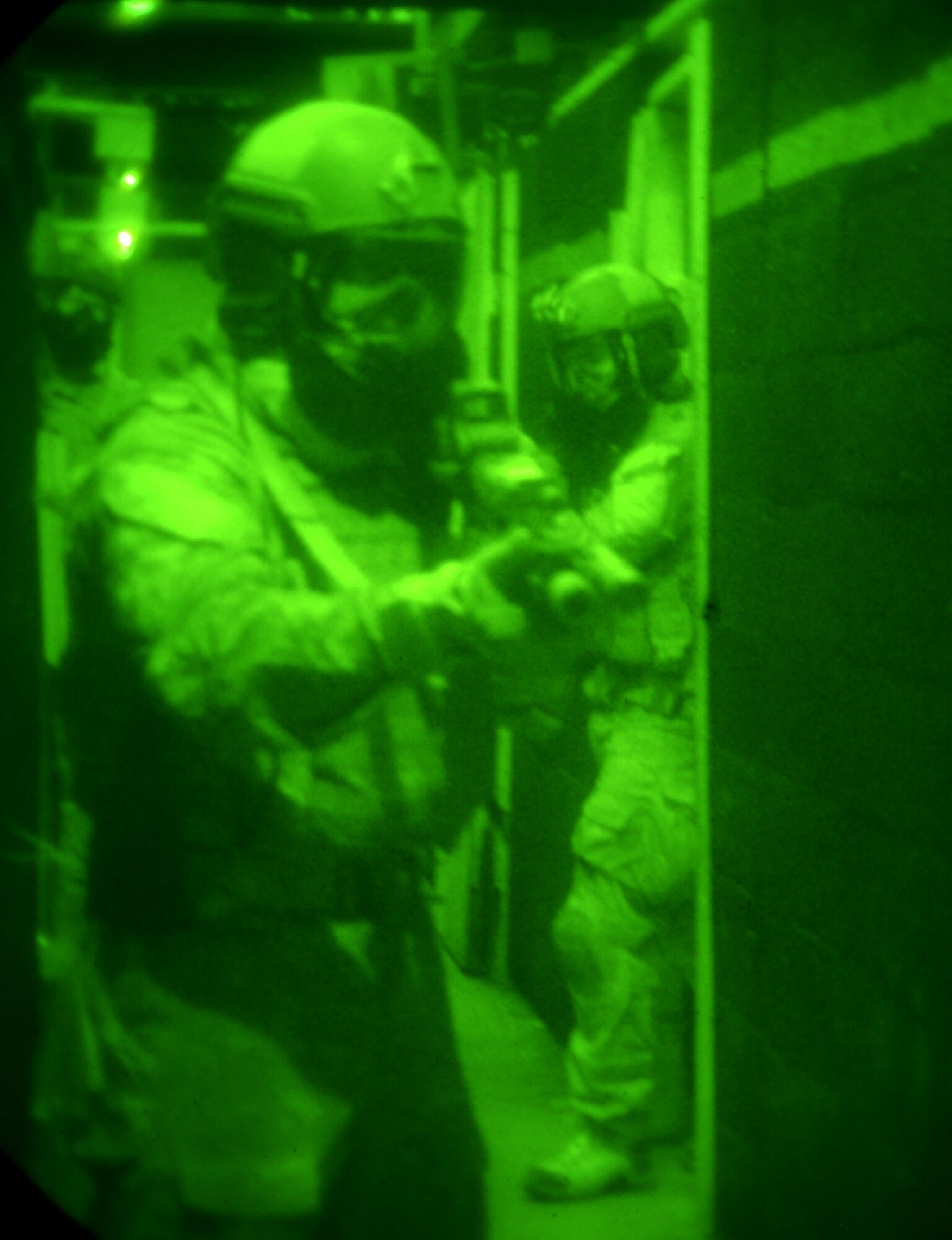A team of Airmen from the 320th Special Tactics Squadron move down the hallway in a shoot house on Camp Hansen Aug. 13, 2013. The Airmen cleared the house as part of the Direct Action Resource Center Training. DARC is a two-week course where a group of pararescue, combat controller and survival, evasion, resistance, escape specialists learn skills they can use when they deploy with other joint special operations teams. (U.S. Air Force photo by Tech. Sgt. Kristine Dreyer)