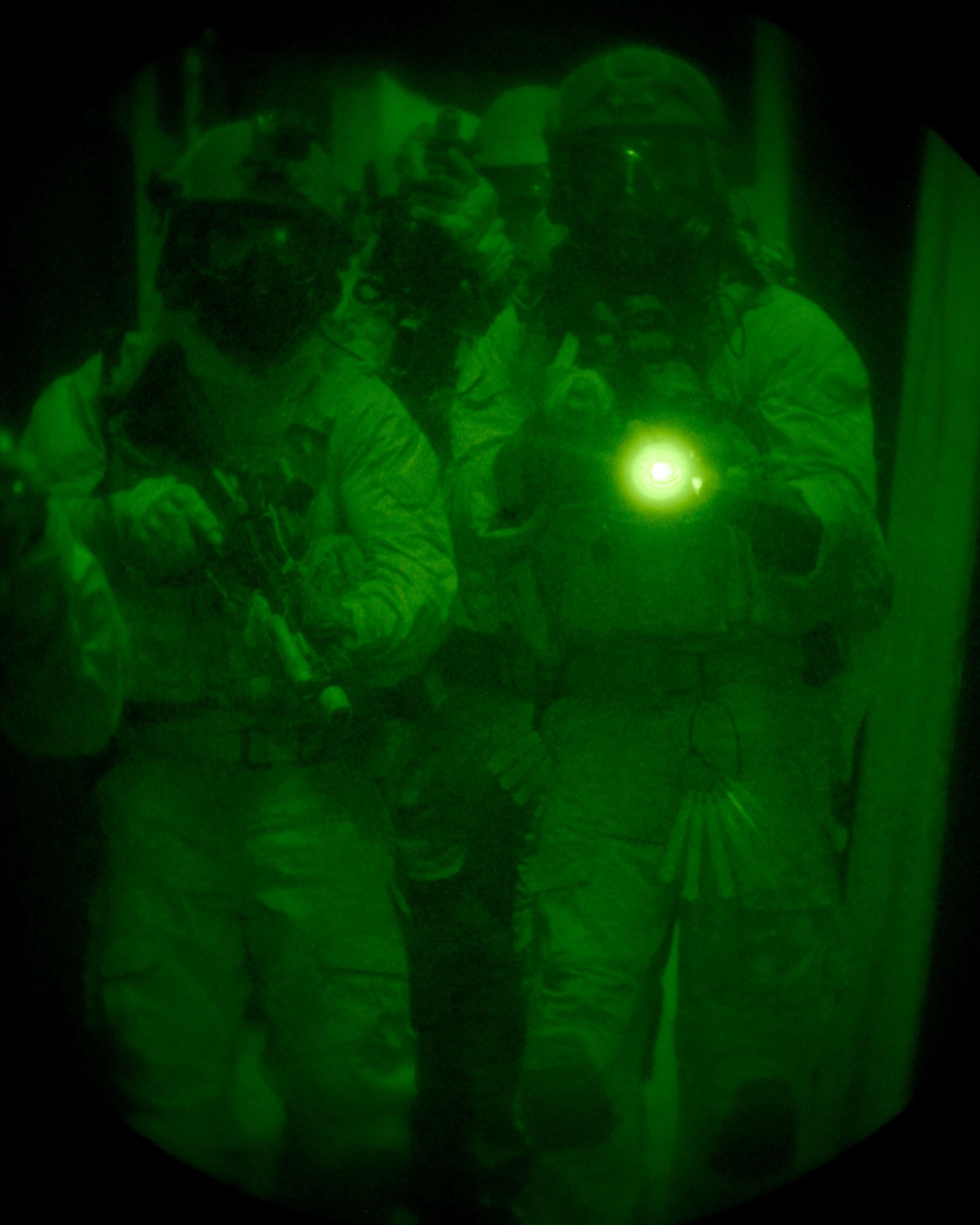 A team of Airmen from the 320th Special Tactics Squadron move down the hallway in a shoot house on Camp Hansen Aug. 13, 2013. The Airmen cleared the house as part of the Direct Action Resource Center Training. DARC is a two-week course where a group of pararescue, combat controller and survival, evasion, resistance, escape specialists learn skills they can use when they deploy with other joint special operations teams. (U.S. Air Force photo by Tech. Sgt. Kristine Dreyer)