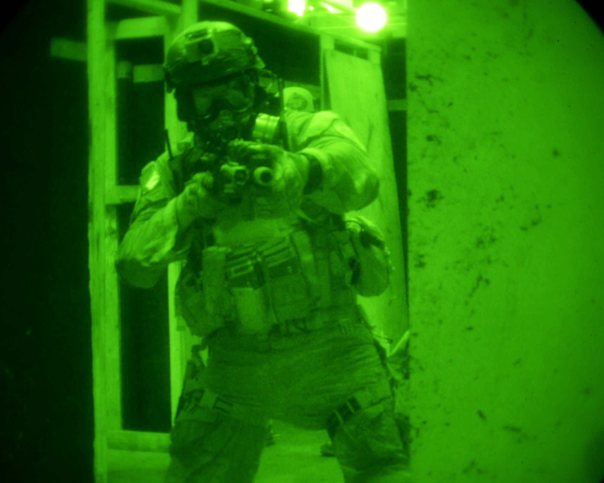 An Airman from the 320th Special Tactics Squadron clears a room in a shoot house on Camp Hansen Aug. 13, 2013. The Airmen cleared the house as part of the Direct Action Resource Center Training. DARC is a two-week course where a group of pararescue, combat controller and survival, evasion, resistance, escape specialists learn skills they can use when they deploy with other joint special operations teams. (U.S. Air Force photo by Tech. Sgt. Kristine Dreyer)