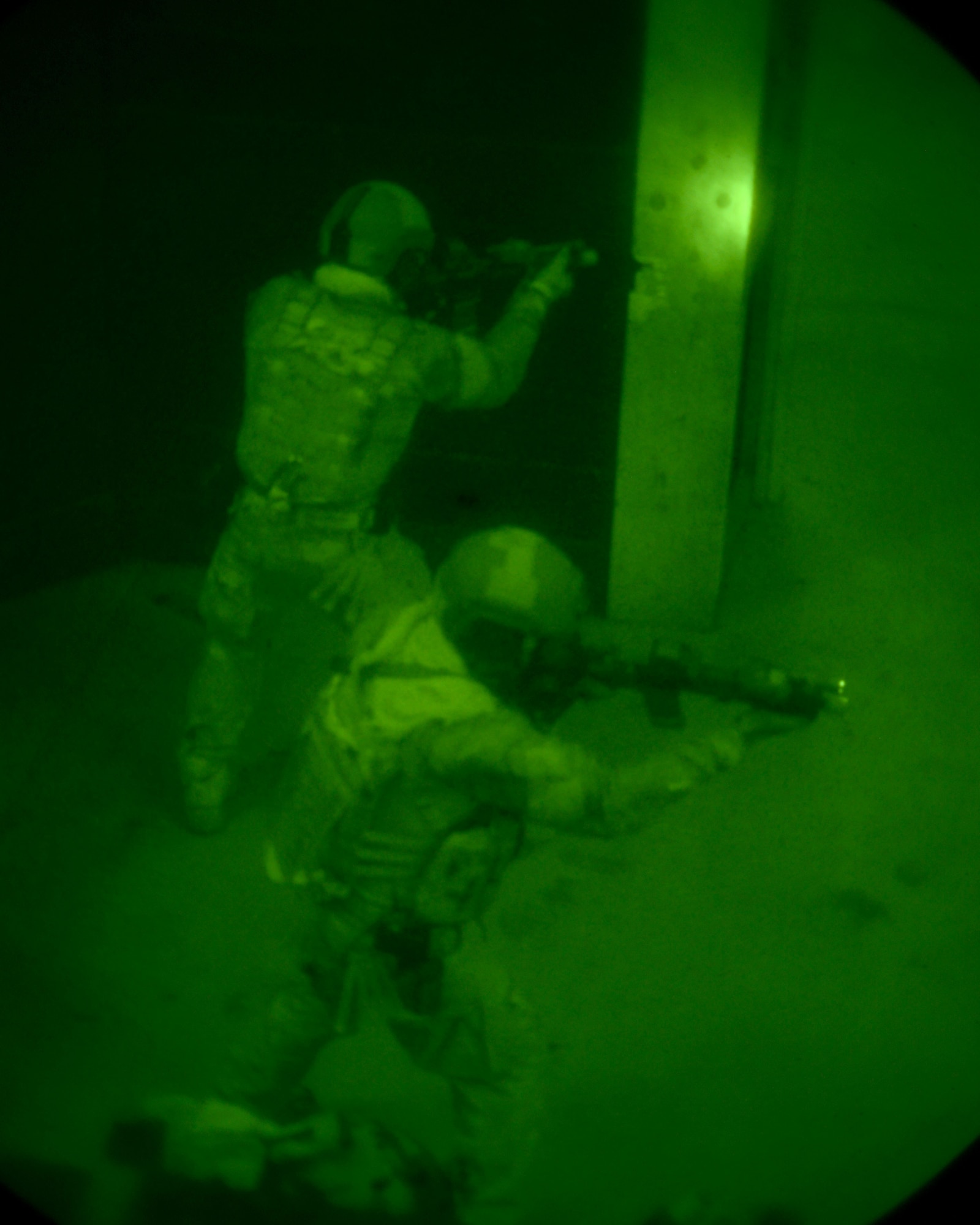 One Airman provides cover while the other moves through to clear the rest of the room in a shoot house on Camp Hansen Aug. 13, 2013. The Airmen cleared the house as part of the Direct Action Resource Center training. DARC is a two-week course where a group of pararescue, combat controller and survival, evasion, resistance, escape specialists learn skills they can use when they deploy with other joint special operations teams. (U.S. Air Force photo by Tech. Sgt. Kristine Dreyer)