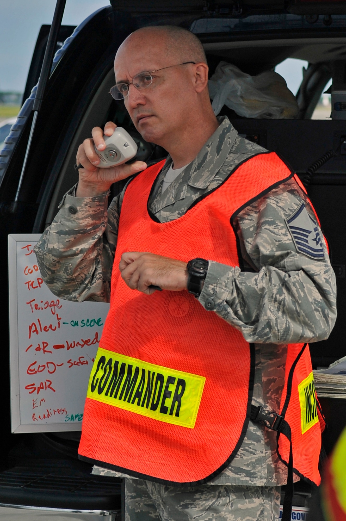 U.S. Air Force Master Sgt. Randall Swisher, 35th Civil Engineer Squadron exercise on-scene commander, passes an update over the radio during a Major Accident Response Exercise at Misawa Air Base, Japan, Sept. 6, 2013. The purpose of a MARE is to test the response speed and actions of emergency-responders. (U.S. Air Force photo by Airman 1st Class Zachary Kee)