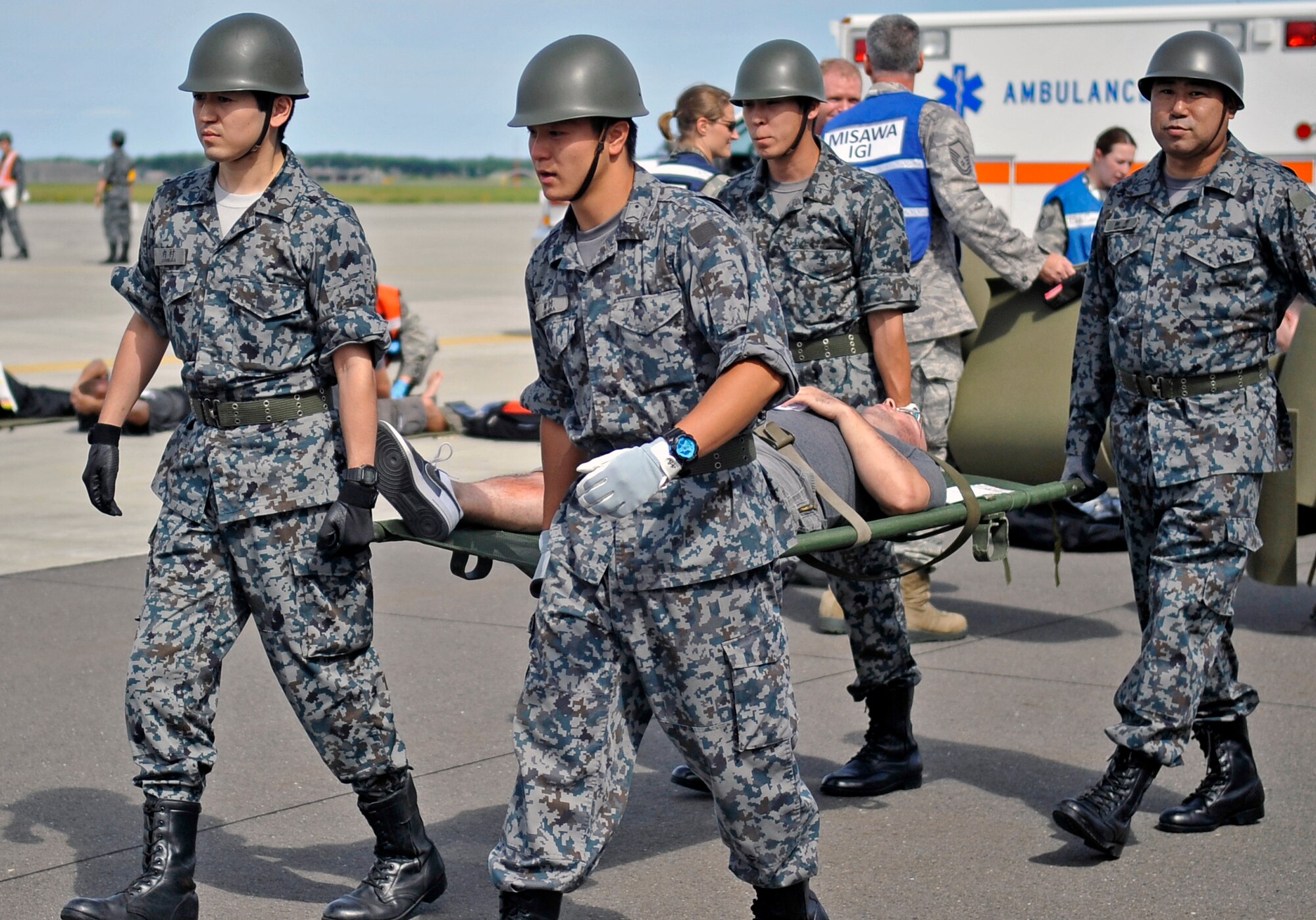 Members of the Japan Air Self-Defense Force carry a simulated casualty on a stretcher during a Major Accident Response Exercise at Misawa Air Base, Japan, Sept. 6, 2013. The MARE is designed to help prepare emergency responders in case of a real-world major accident during the upcoming Misawa Air Festival. (U.S. Air Force photo by Airman 1st Class Zachary Kee) 
