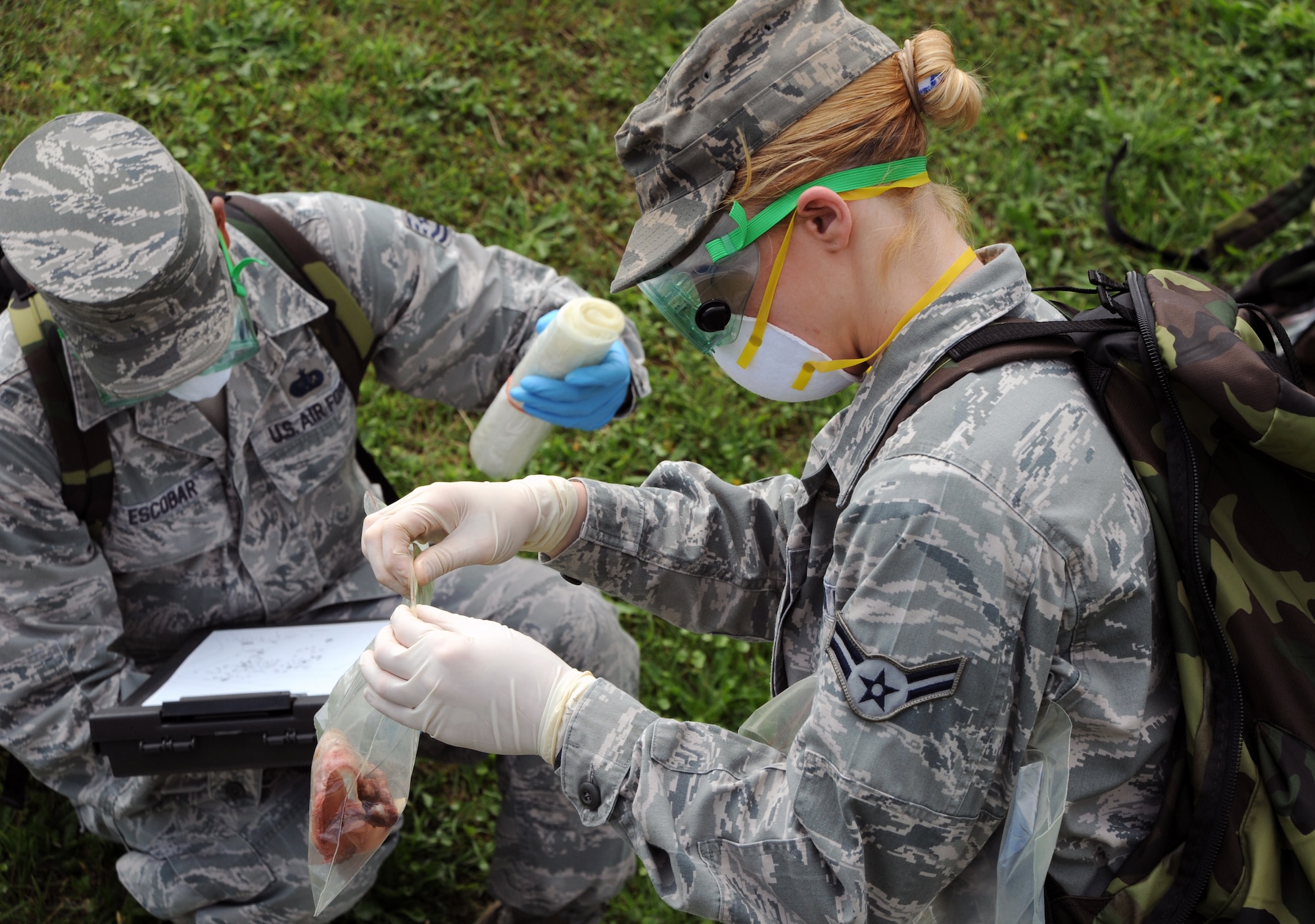 U.S. Air Force Airman 1st Class Katie Young, 35th Force Support Squadron, performs recovery operations during a simulated aircraft accident at Misawa Air Base, Japan, Sept. 6, 2013. Young was part of a search and recovery team during a Major Accident Response Exercise that helped prepare emergency responders for the possibility of real-world accidents. (U.S. Air Force photo by Senior Airman Derek VanHorn)